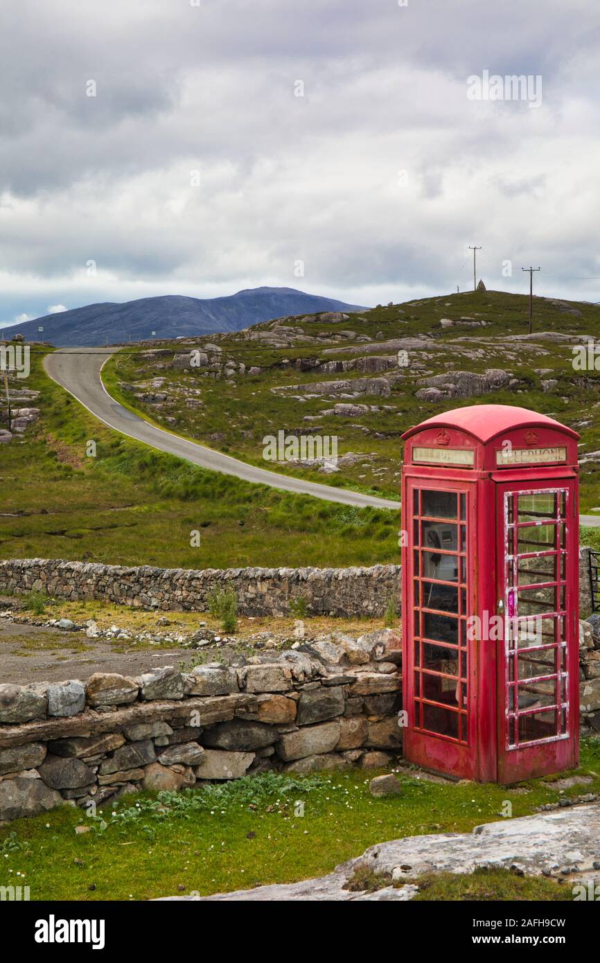 Remote traditional red phone box by a single track road on the island of Harris, Outer Hebrides, Scotland Stock Photo