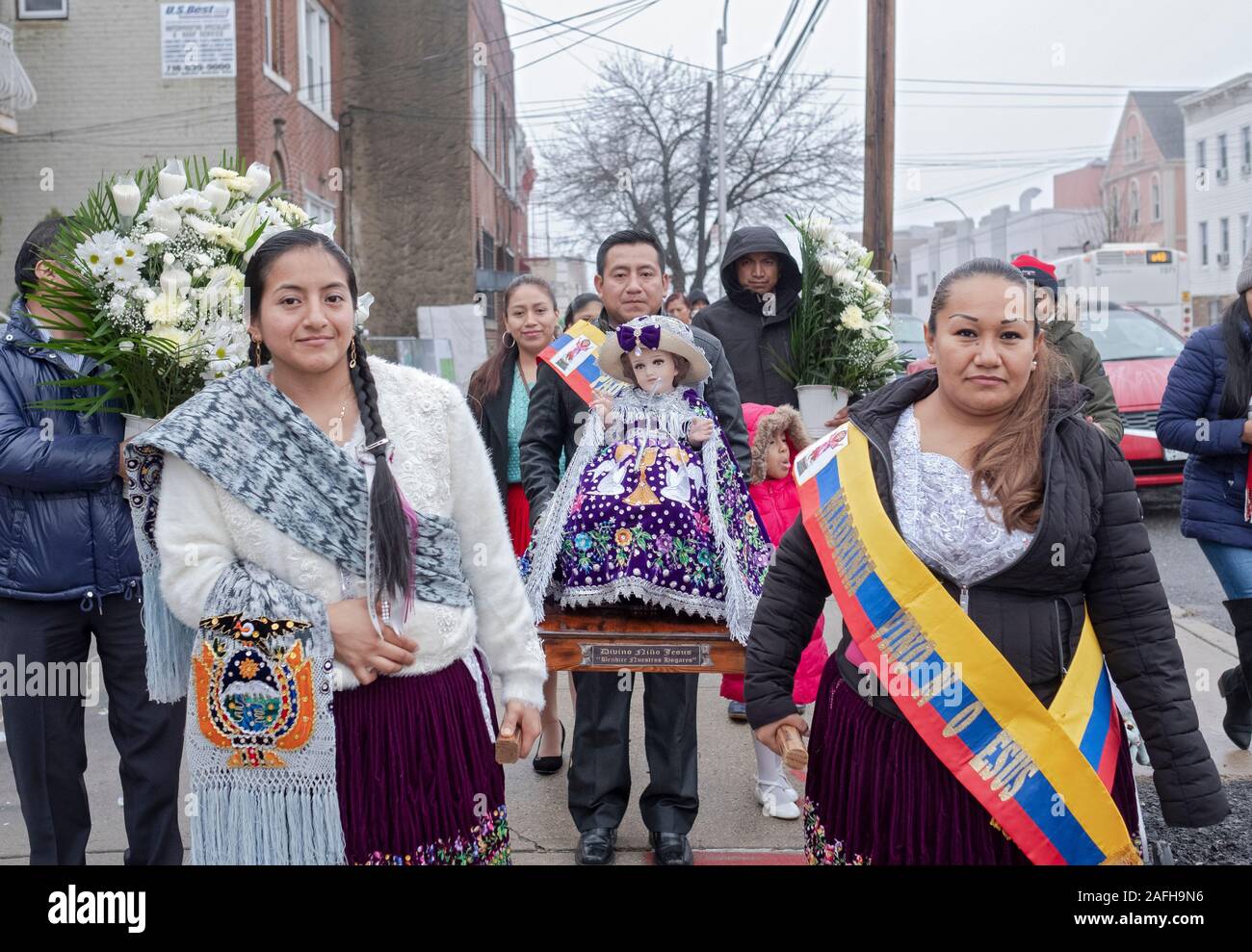 Ecuadorian Americans Catholics in mid December march with statues of Baby Jesus to celebrate the birth of Christ. In Corona, Queens, New York City. Stock Photo