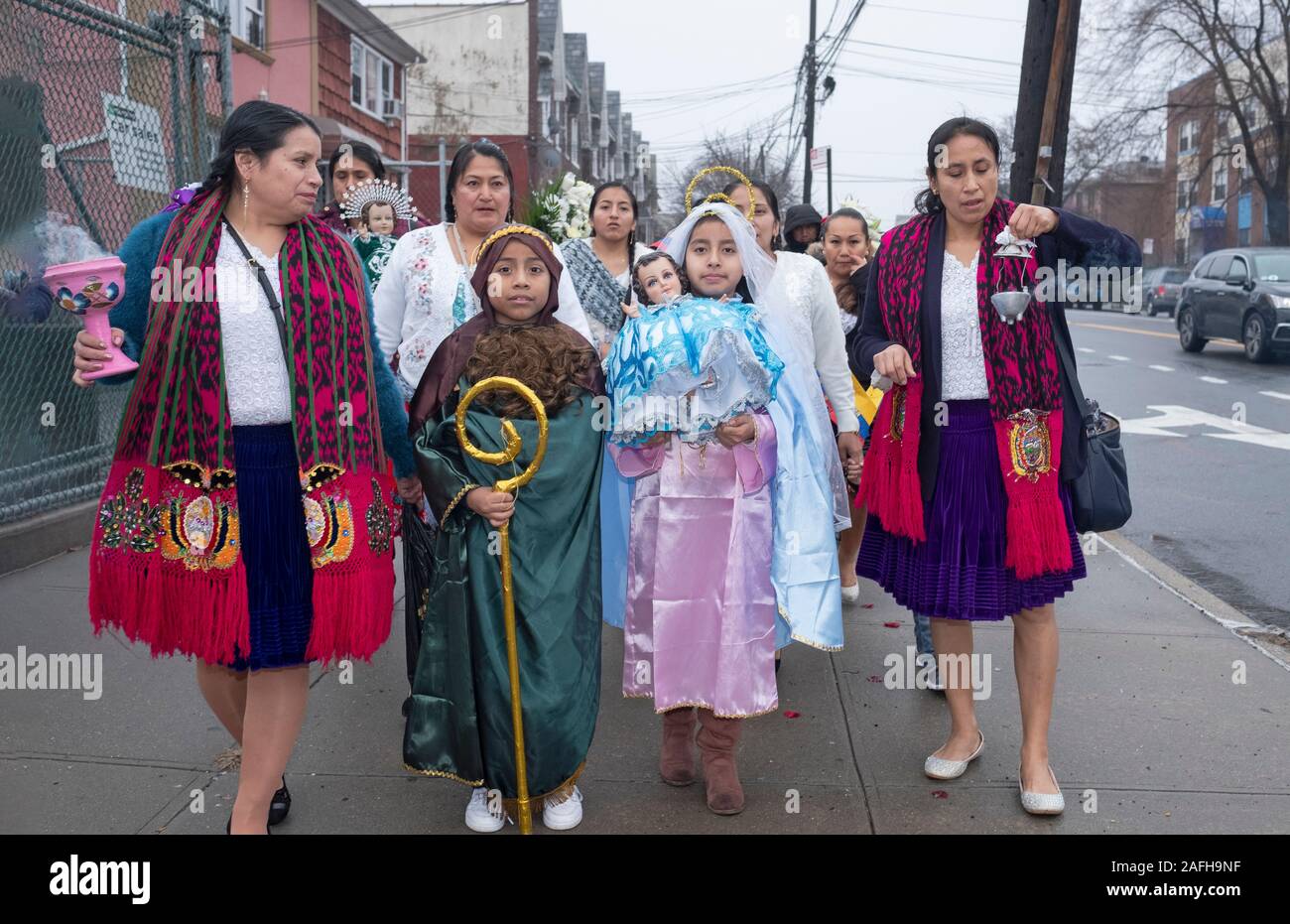 Ecuadorian Americans Catholics march in mid December to celebrate the birth of Jesus. The children are dressed as Joseph & Mary. Corona, Queens, NYC. Stock Photo