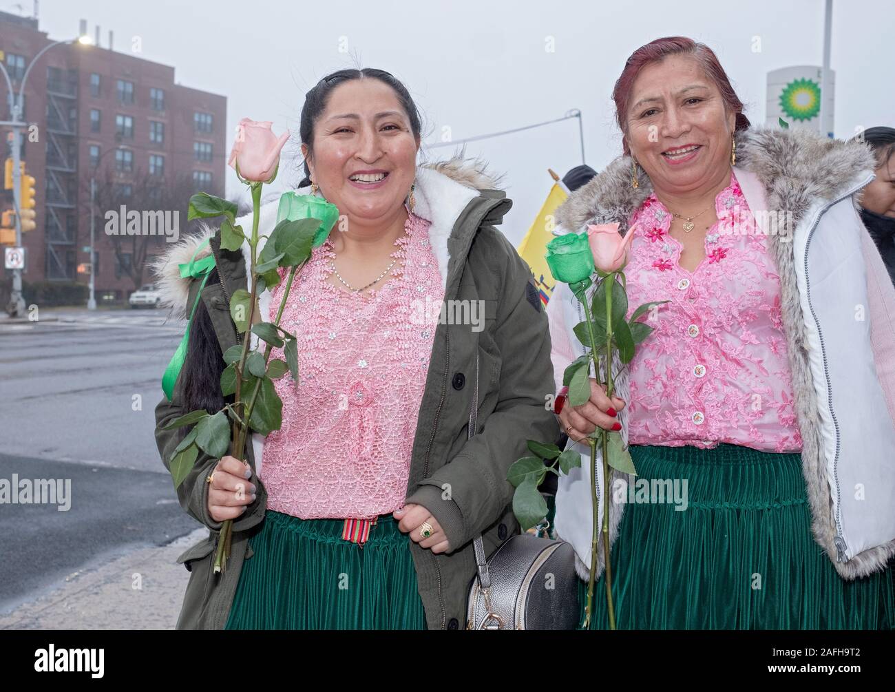 Posed portrait of Ecuadorian Americans sisters at a march in mid December to celebrate the birth of Jesus. In Corona, Queens, New York City. Stock Photo