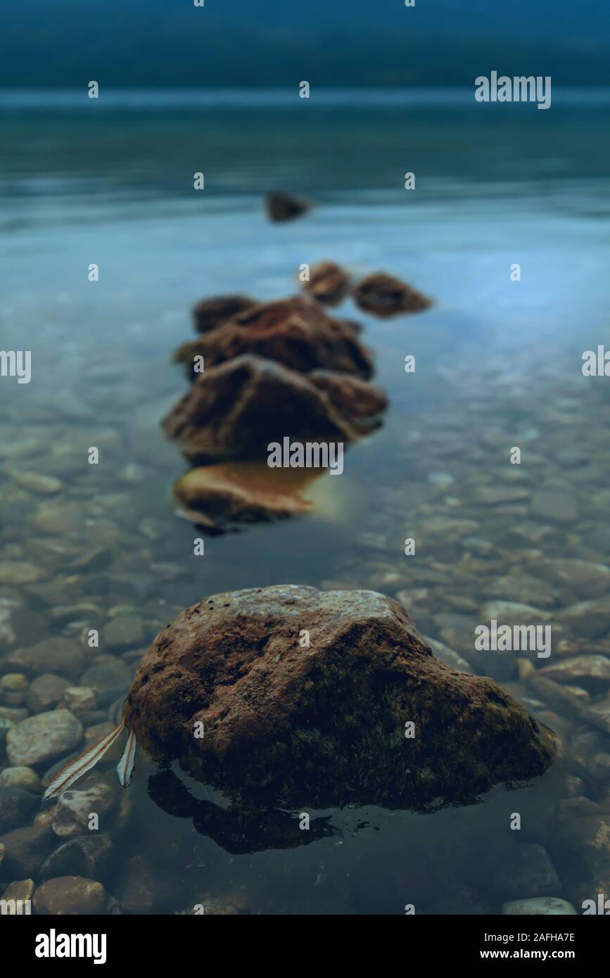 Crack of dawn on Lake Bohinj in Slovenia, beautiful tranquil landscape with autumnal fog on the lakeshore Stock Photo