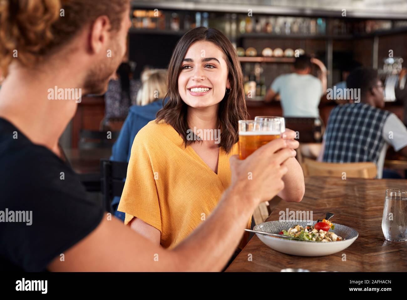 Couple On Date Meeting For Drinks And Food Making A Toast In Restaurant Stock Photo Alamy