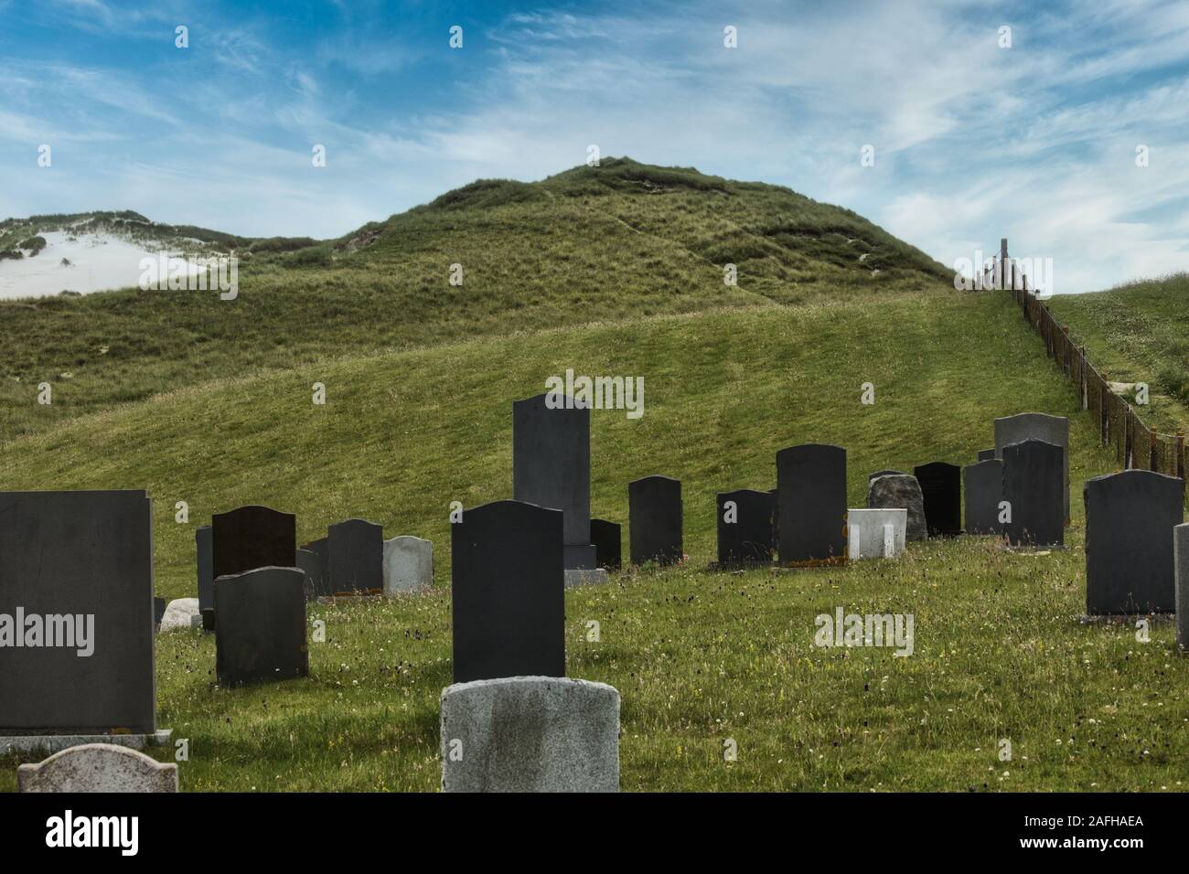 Blank gravestones headstones in graveyard behind sand dunes at Hushinish, Isle of Harris, Outer Hebrides, Scotland Stock Photo