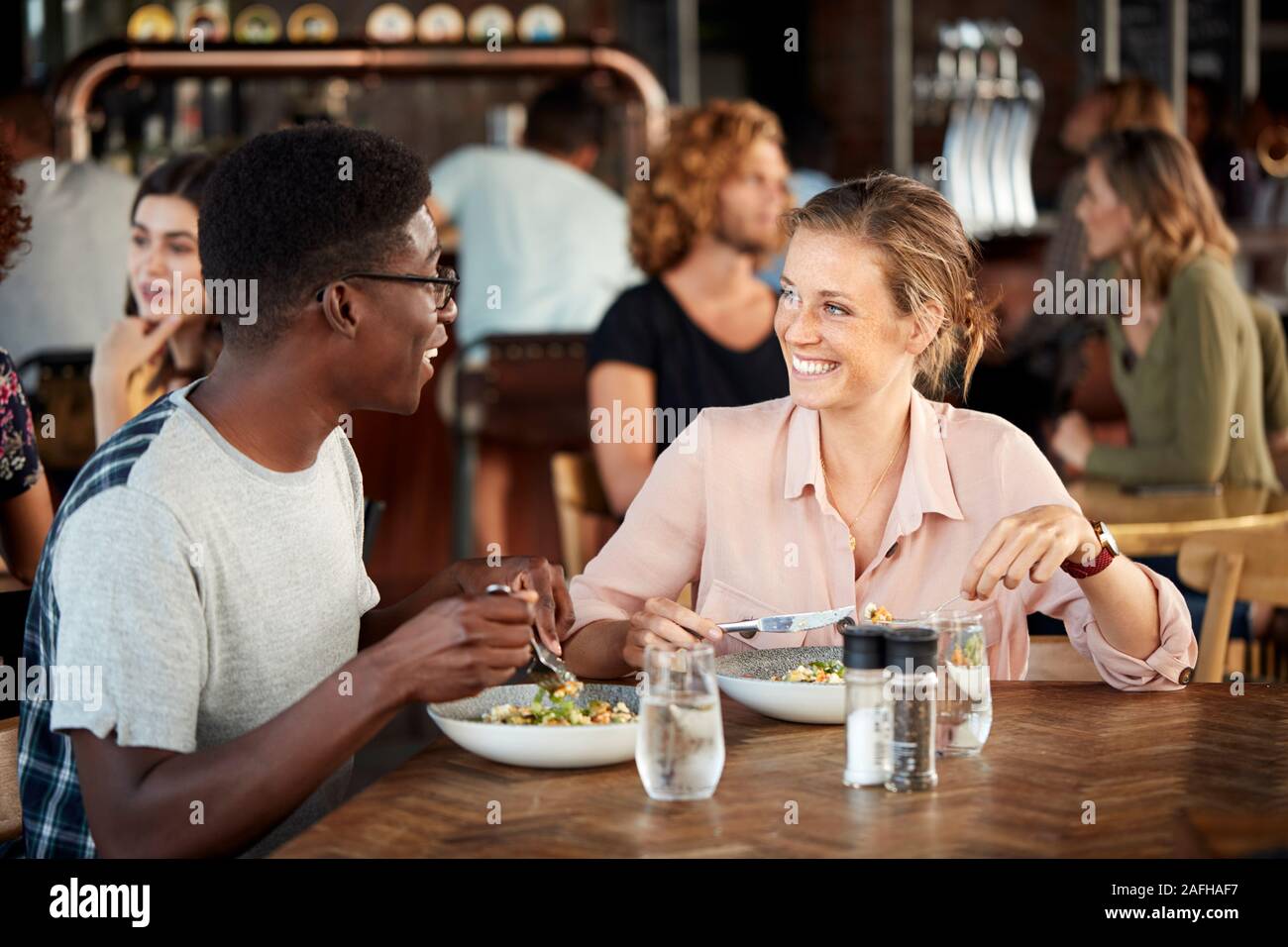 Couple On Date Meeting For Drinks And Food Making A Toast In Restaurant Stock Photo Alamy