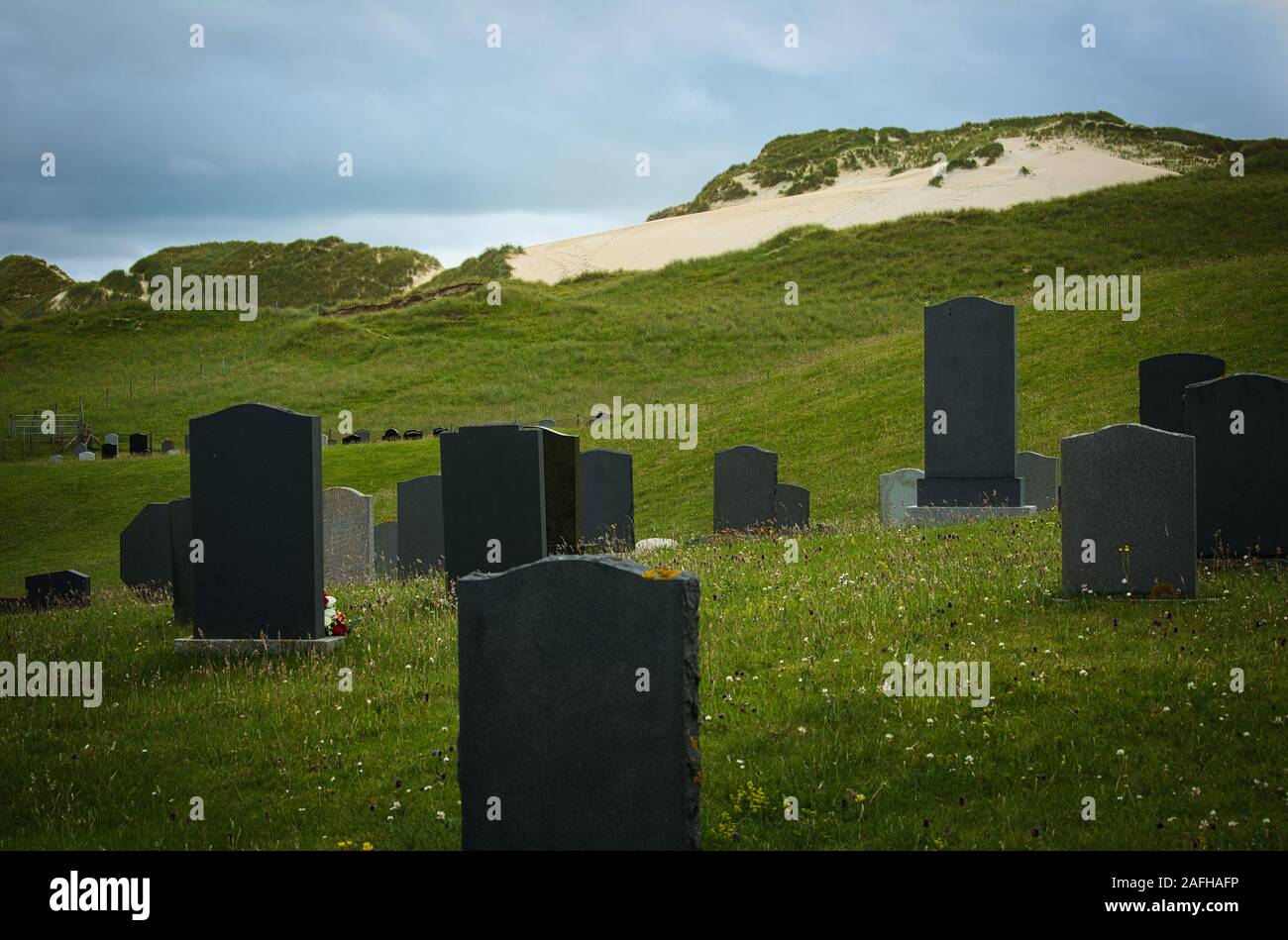 Blank gravestones headstones in graveyard behind sand dunes at Hushinish, Isle of Harris, Outer Hebrides, Scotland Stock Photo