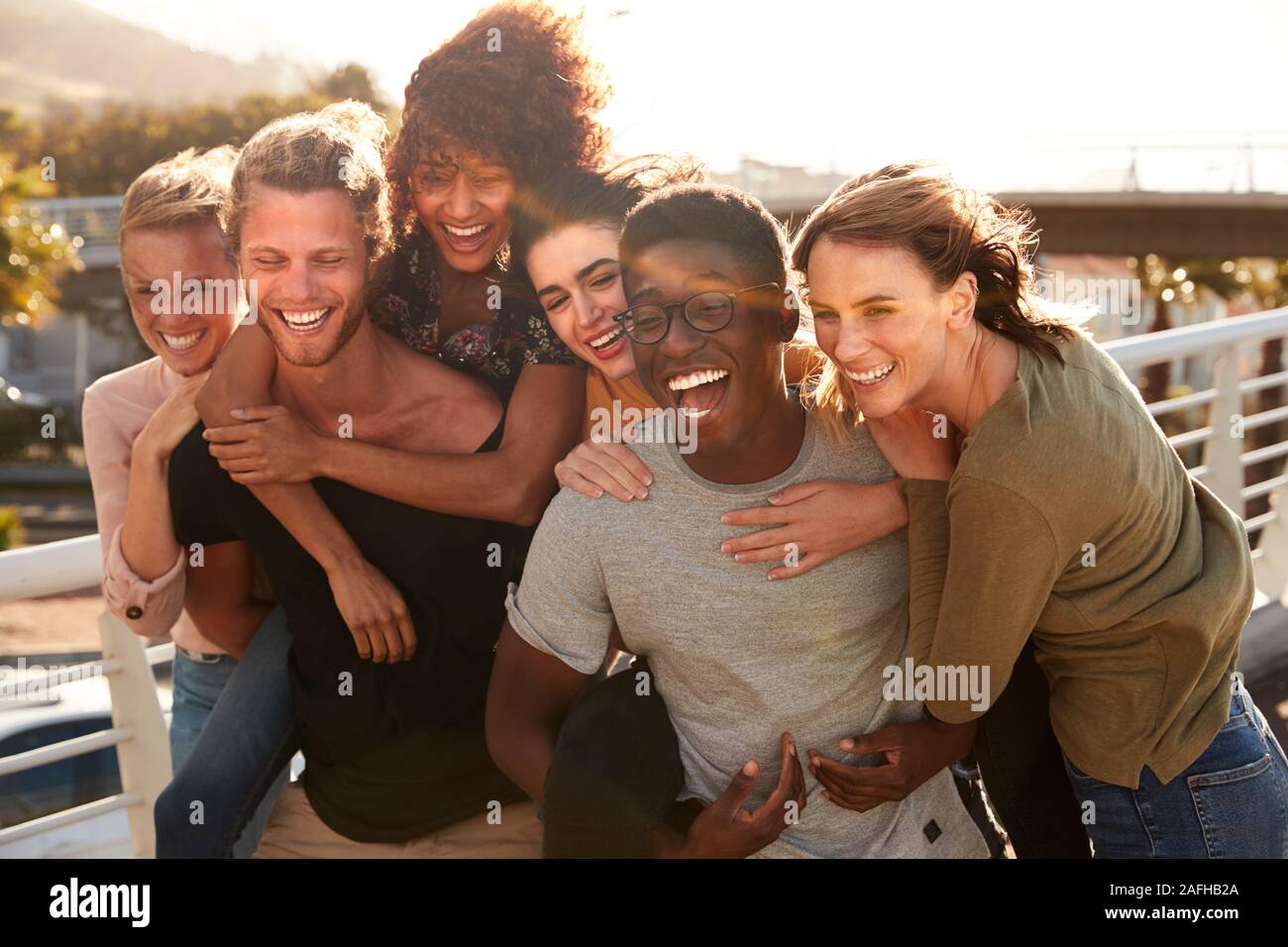 Smiling Young Friends Walking Outdoors Together Stock Photo