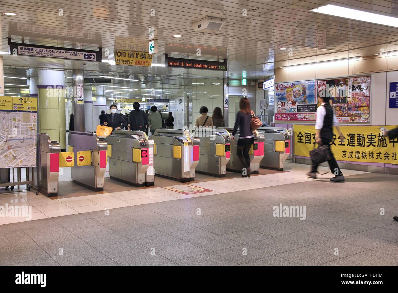 TOKYO, JAPAN - APRIL 13, 2012: People enter Toei Metro in Tokyo. With more than 3.1 billion annual passenger rides, Tokyo subway system is the busiest Stock Photo