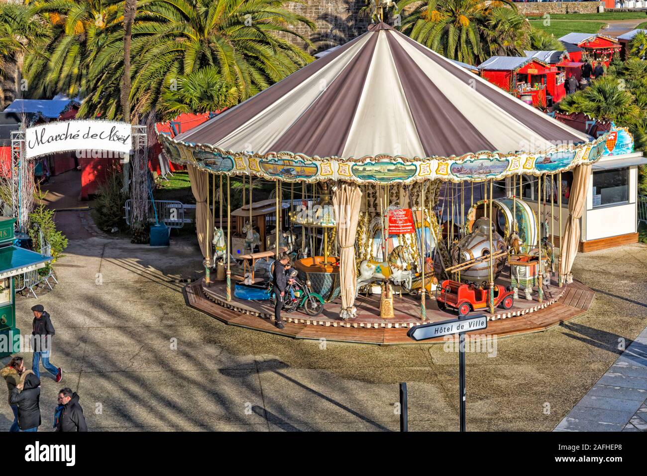 Christmas market and carousel merry-go-round at St Malo, Saint Malo, Brittany, France in December Stock Photo