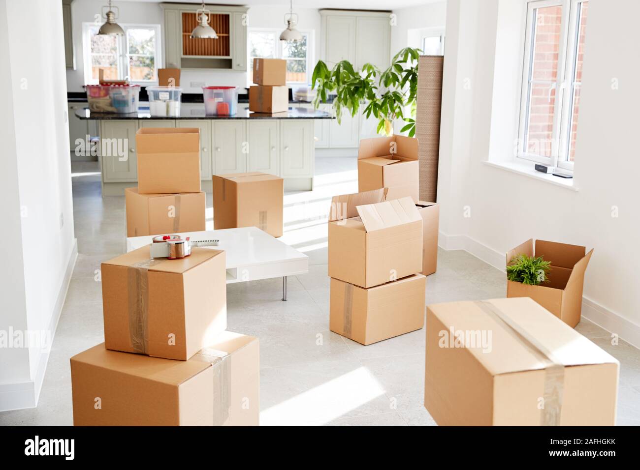 Stacked Removal Boxes In Empty Room On Moving Day Stock Photo