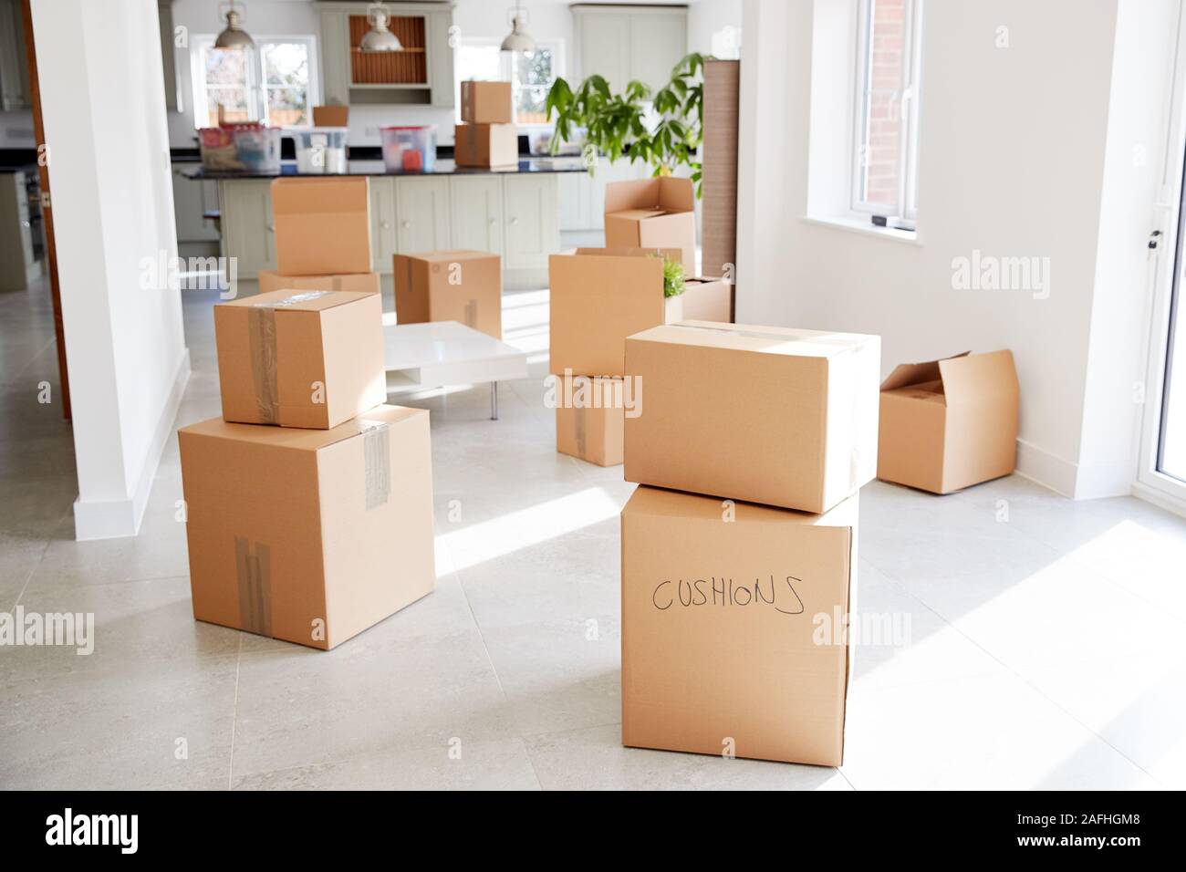 Stacked Removal Boxes In Empty Room On Moving Day Stock Photo