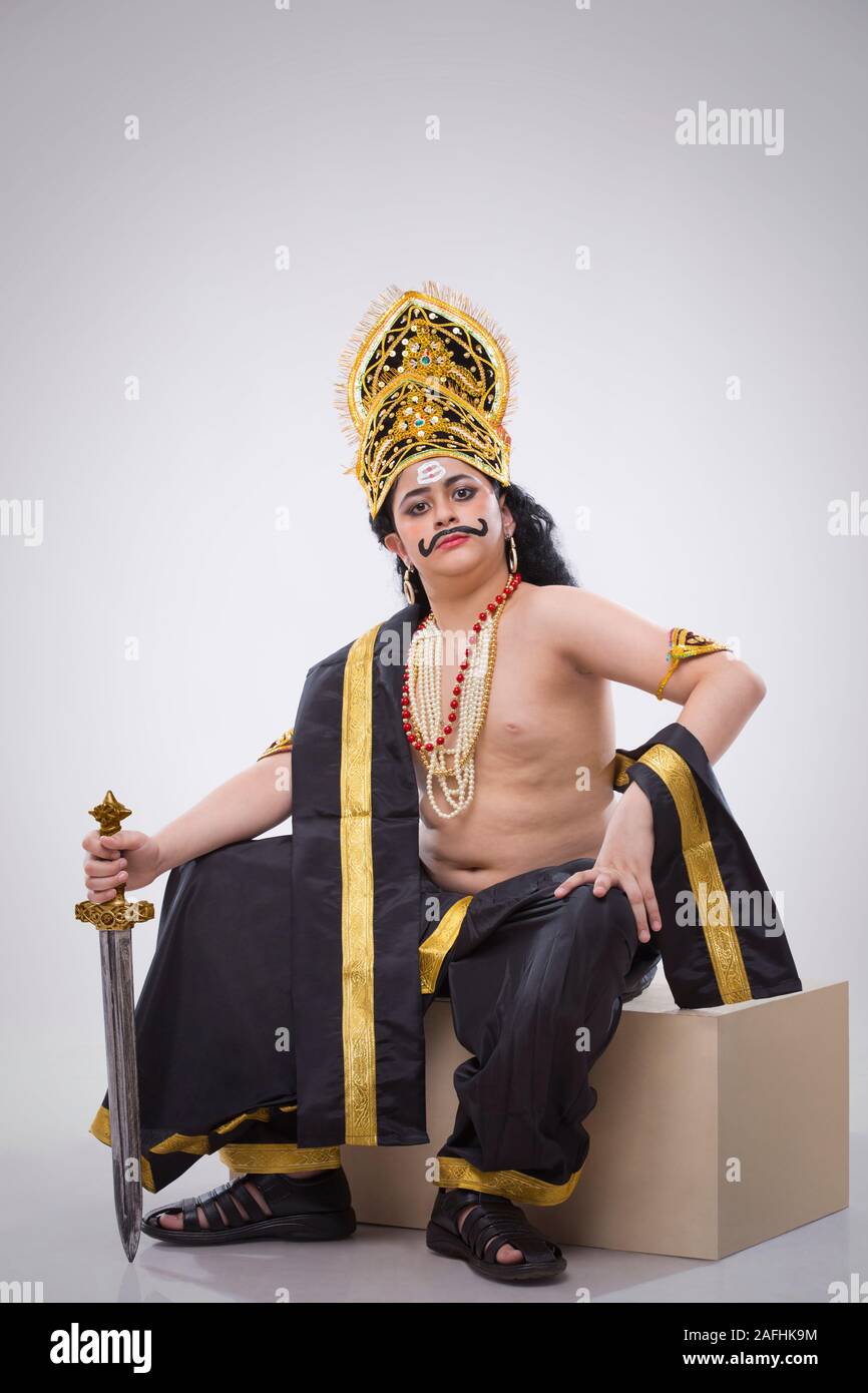 ravan sitting on a table with a sword Stock Photo - Alamy