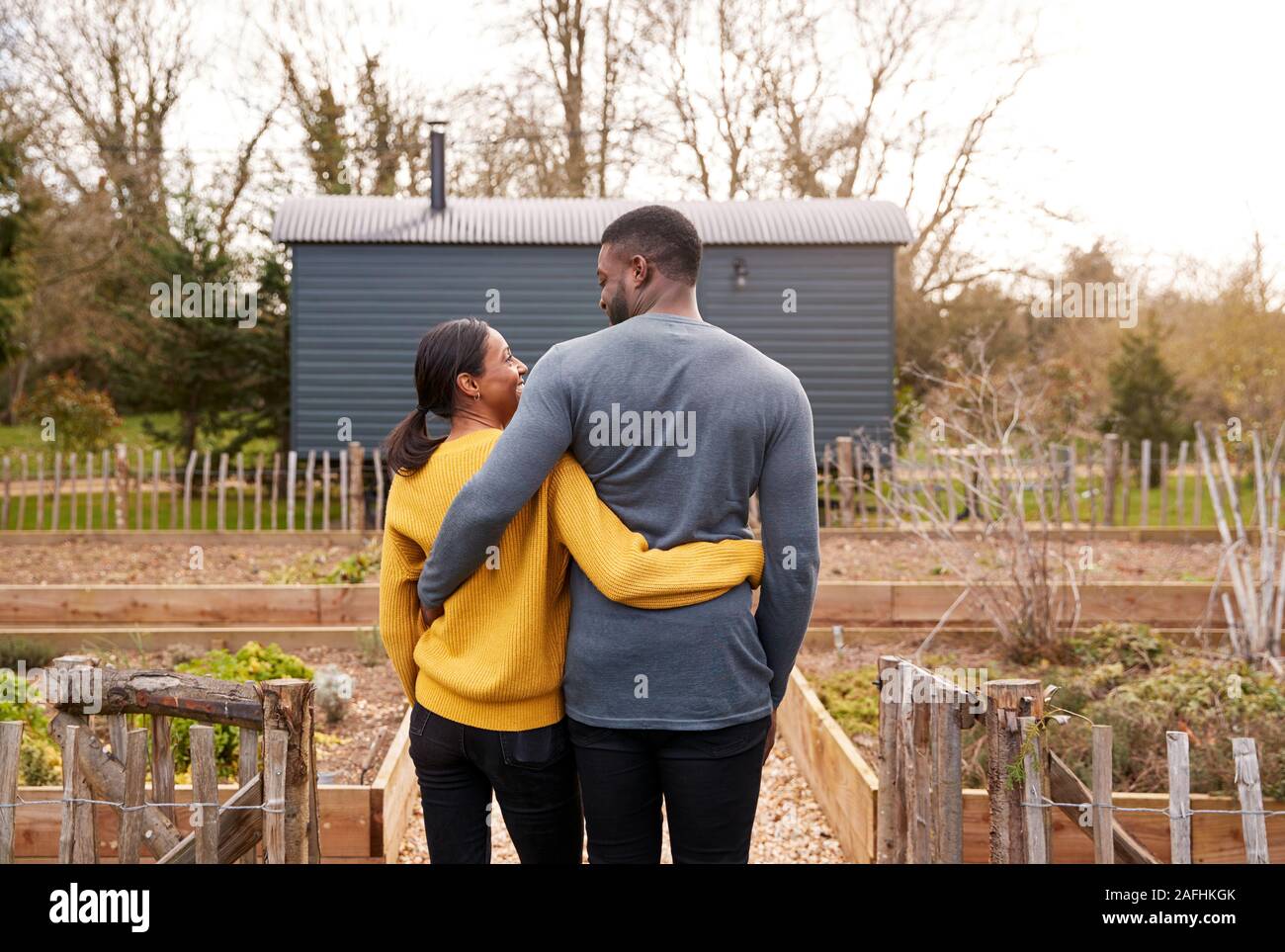 Rear View Of Couple Outdoors Spending Vacation In Eco Lodge Stock Photo