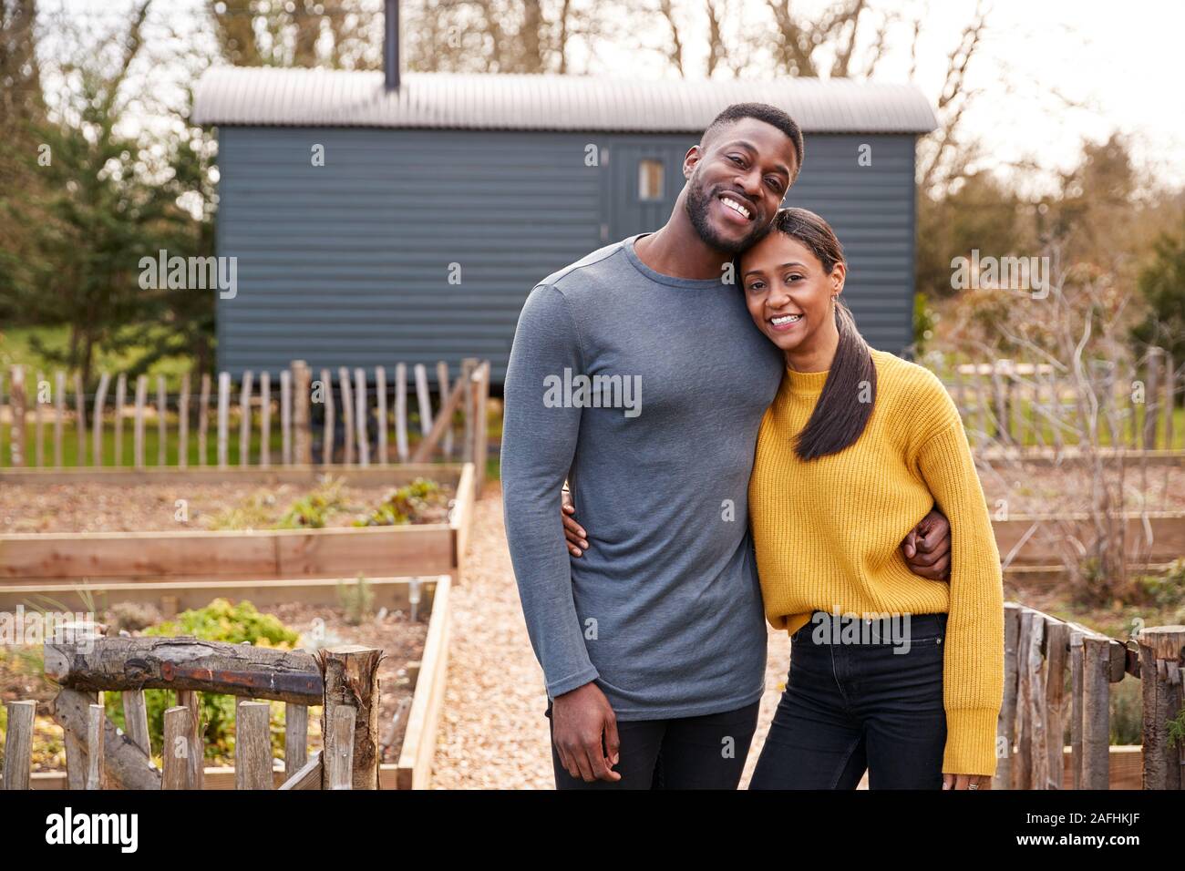 Outdoor Portrait Of Couple Spending Vacation In Eco Lodge Stock Photo