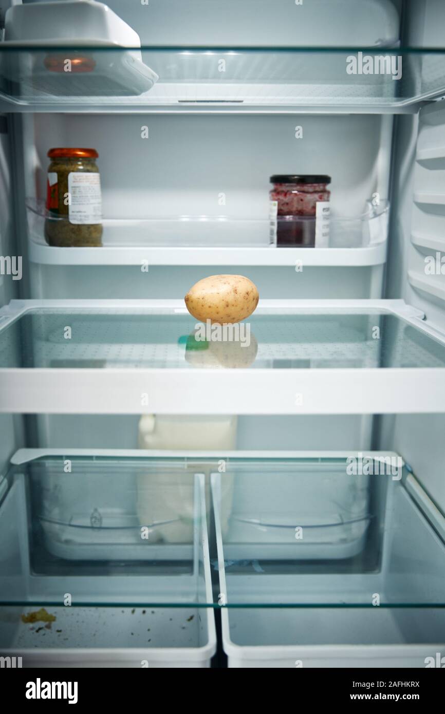 View Looking Inside Refrigerator Empty Except For Potato On Shelf Stock Photo