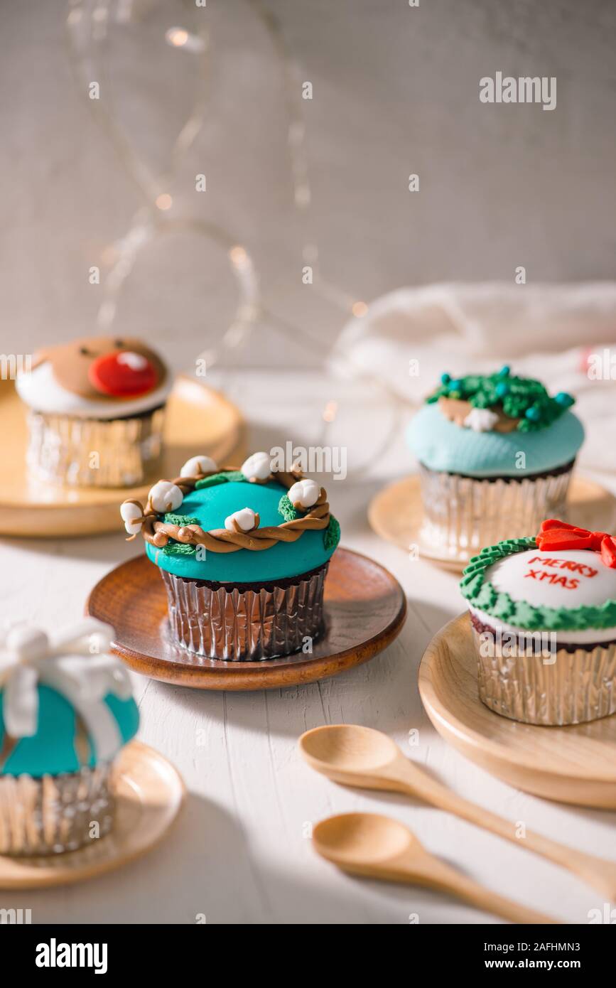Christmas theme cupcakes in traditional red green colors and candy elements from overhead Stock Photo
