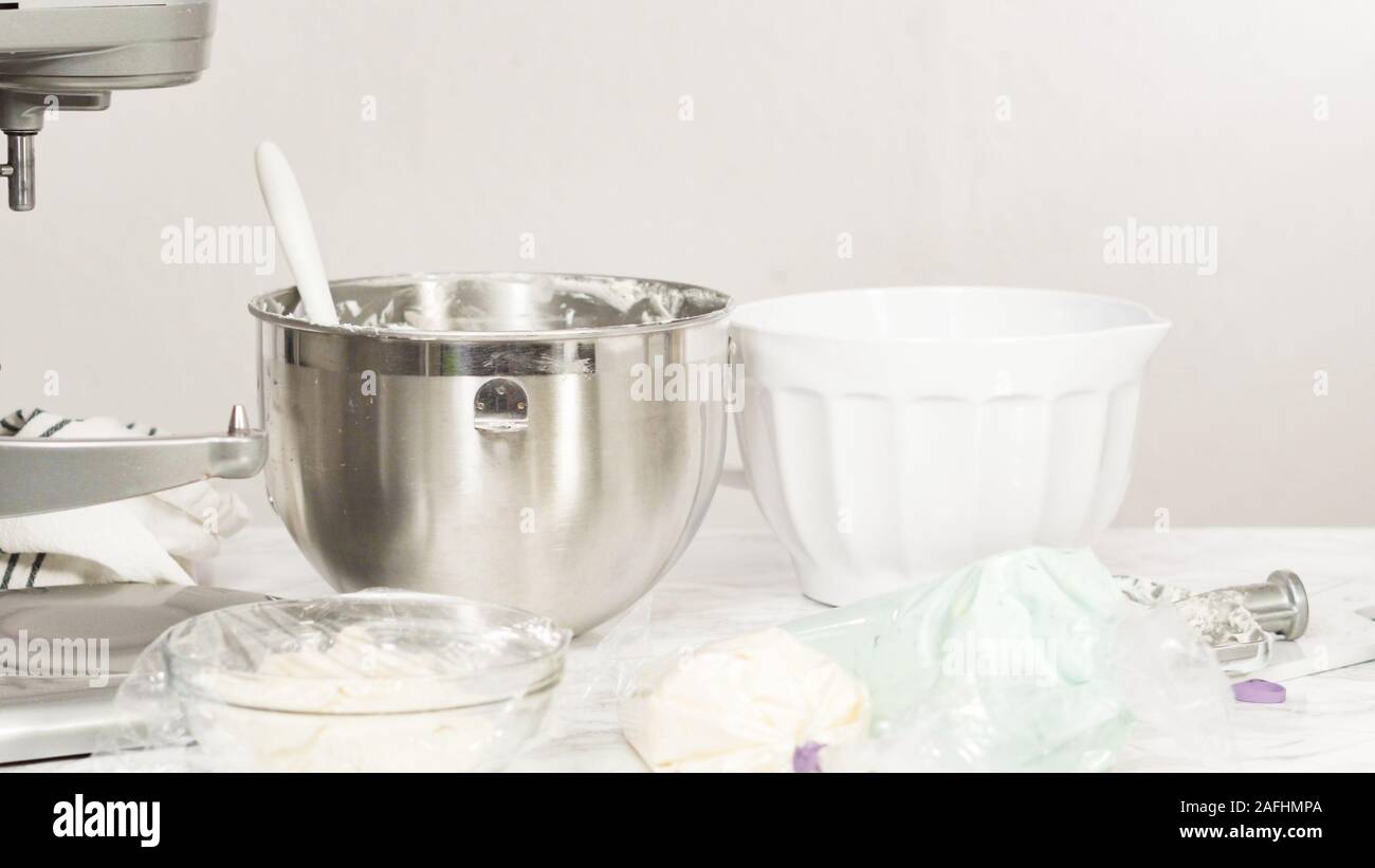 Mixing ingredients in standing kitchen mixer to make buttercream