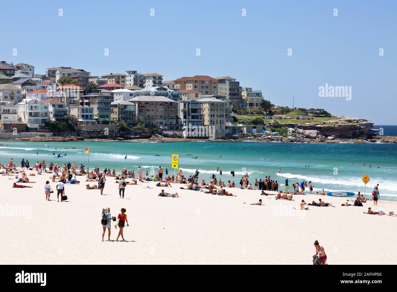 People enjoying the sunshine in summer on Bondi Beach, Sydney New South Wales, Australia Stock Photo