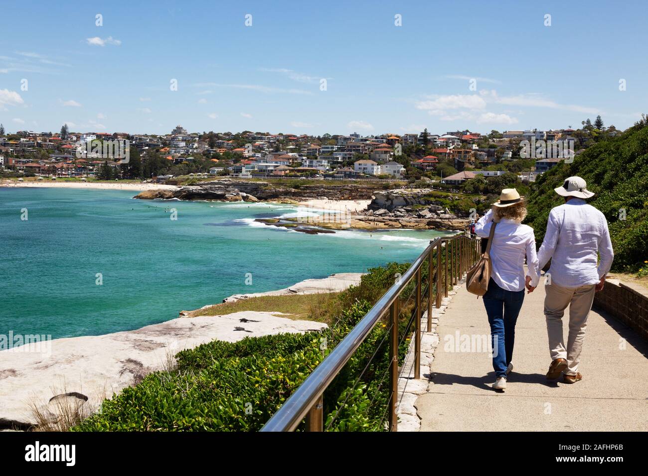 Sydney walking; a couple on the sydney coast, on the Bondi to Clovelly beach walk in spring, arriving at Tamarama and Bronte beaches, Sydney Australia Stock Photo