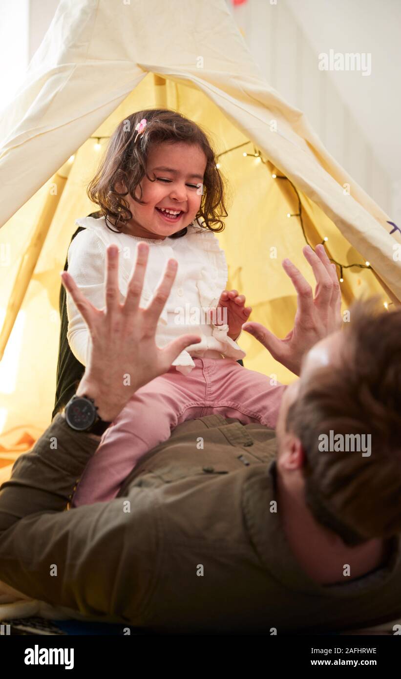 Single Father Playing With Daughter In Den In Bedroom At Home Stock Photo