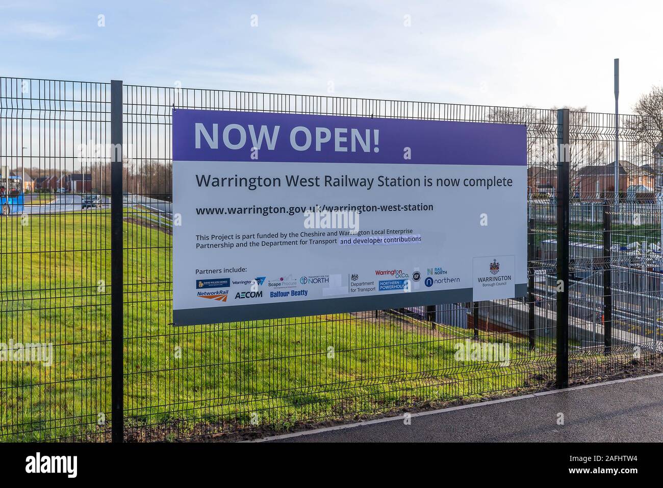 Warrington, Cheshire, UK. 16th Dec, 2019. The official opening of Warrington West Railway Station. A sign on the entry fence of Warrington West Railway Station, Chapelford, Warrington, Cheshire, England states that the station is now open Credit: John Hopkins/Alamy Live News Credit: John Hopkins/Alamy Live News Stock Photo