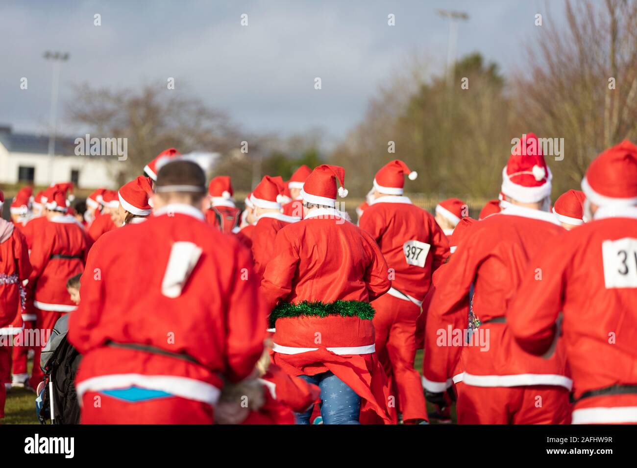 Oxfordshire, UK - December 14th 2019: People dressed as Father Christmas take part in the annual santa fun run. Stock Photo