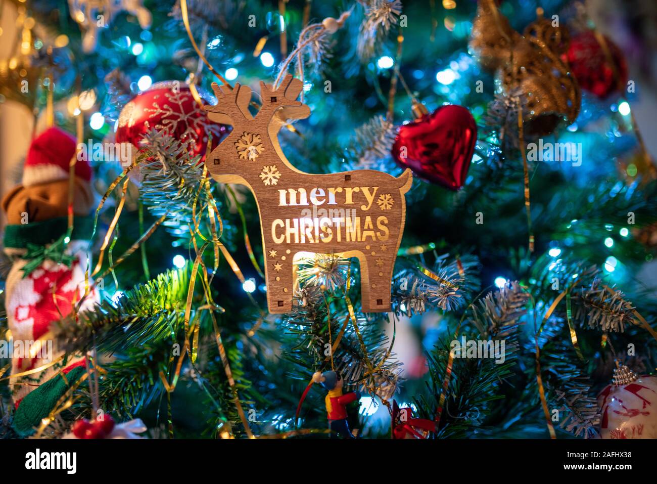 Close Up of a decorated Christmas tree, in the centre a iluminated reindeer. Christmas concept. Stock Photo