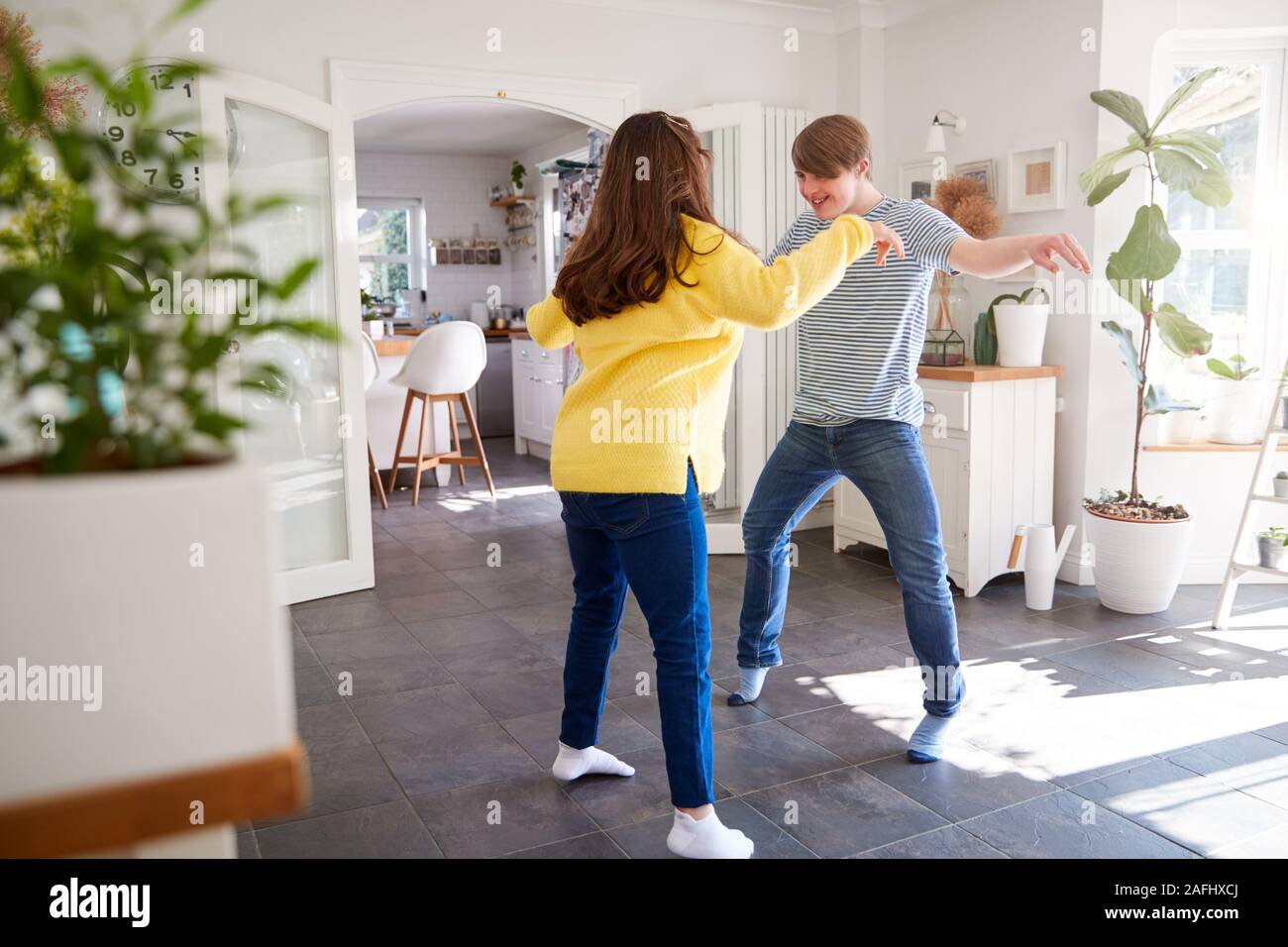 Young Downs Syndrome Couple Having Fun Dancing At Home Together Stock Photo
