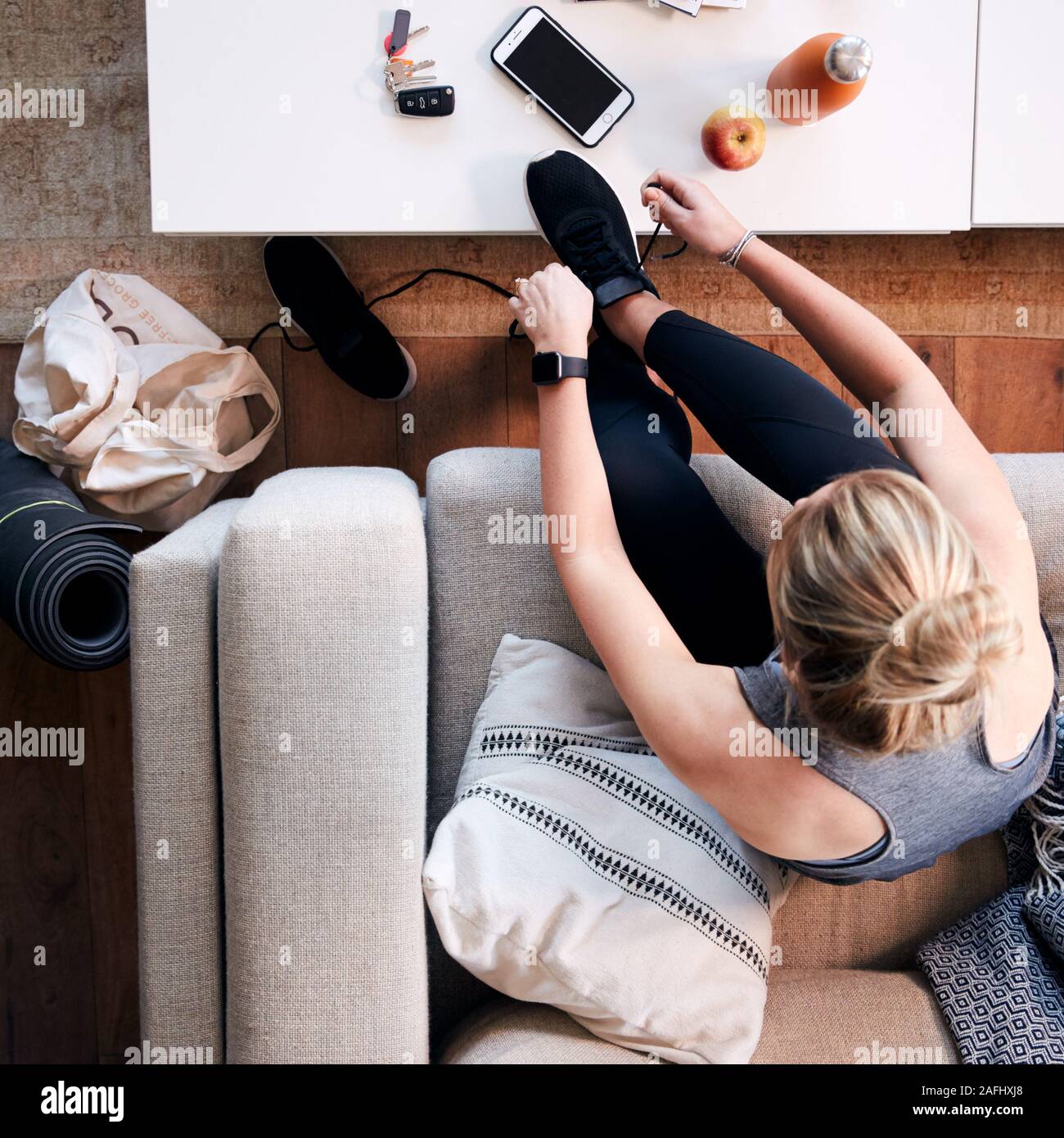 Overhead Shot Looking Down On Woman At Home Getting Ready To Go To Fitness Class Stock Photo