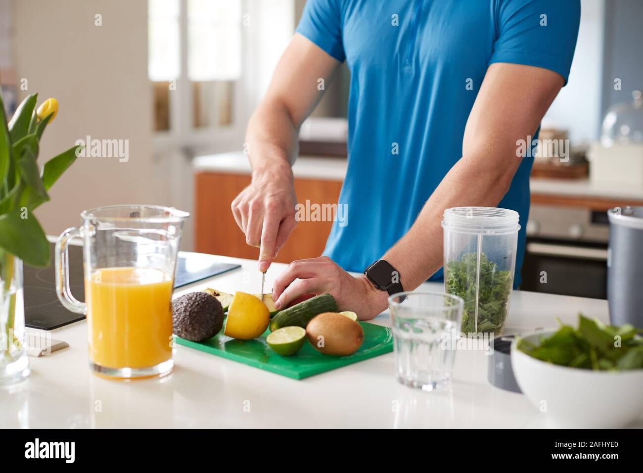 Close Up Of Man Preparing Ingredients For Healthy Juice Drink After Exercise Stock Photo