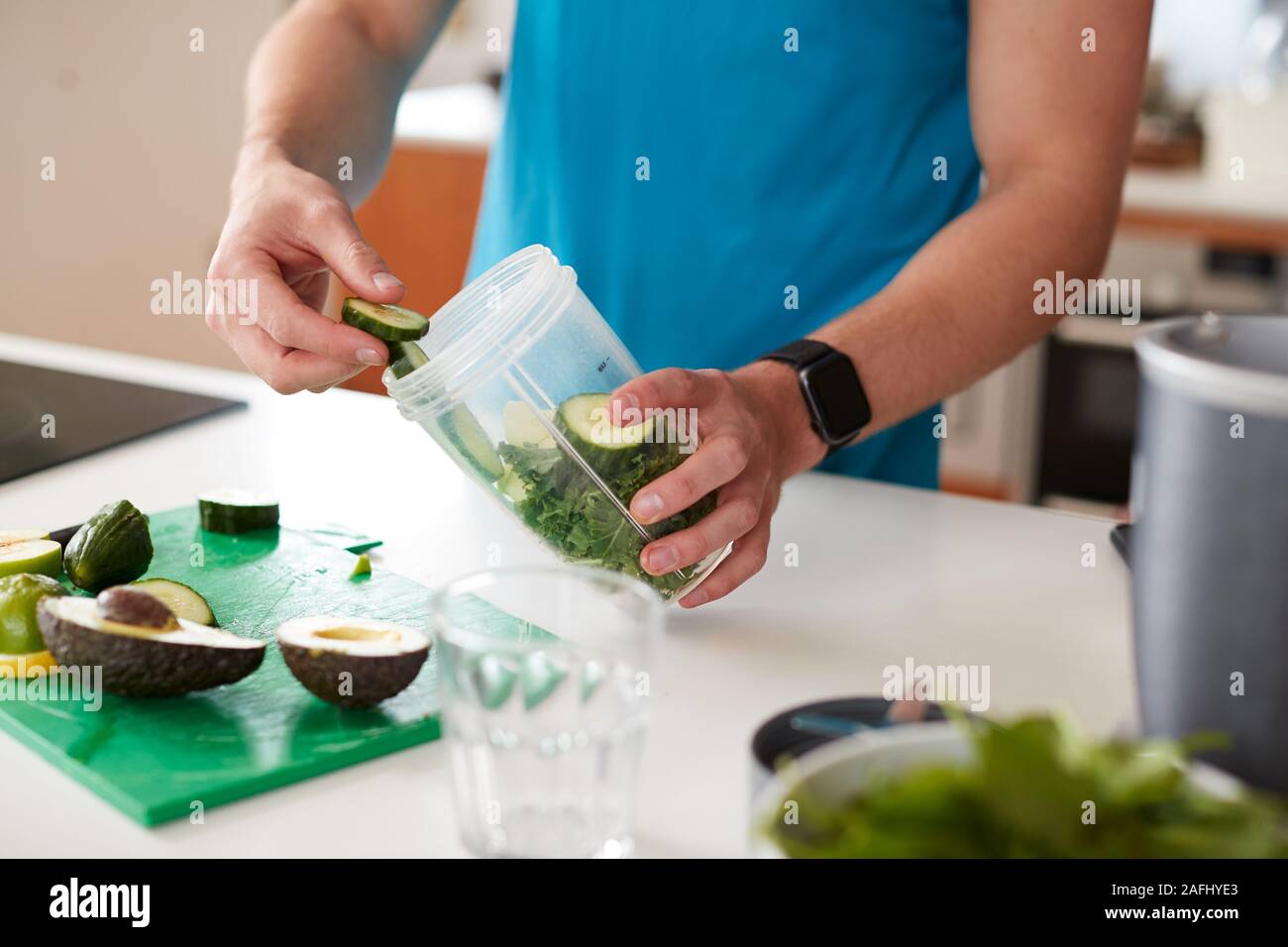 Close Up Of Man Preparing Ingredients For Healthy Juice Drink After Exercise Stock Photo
