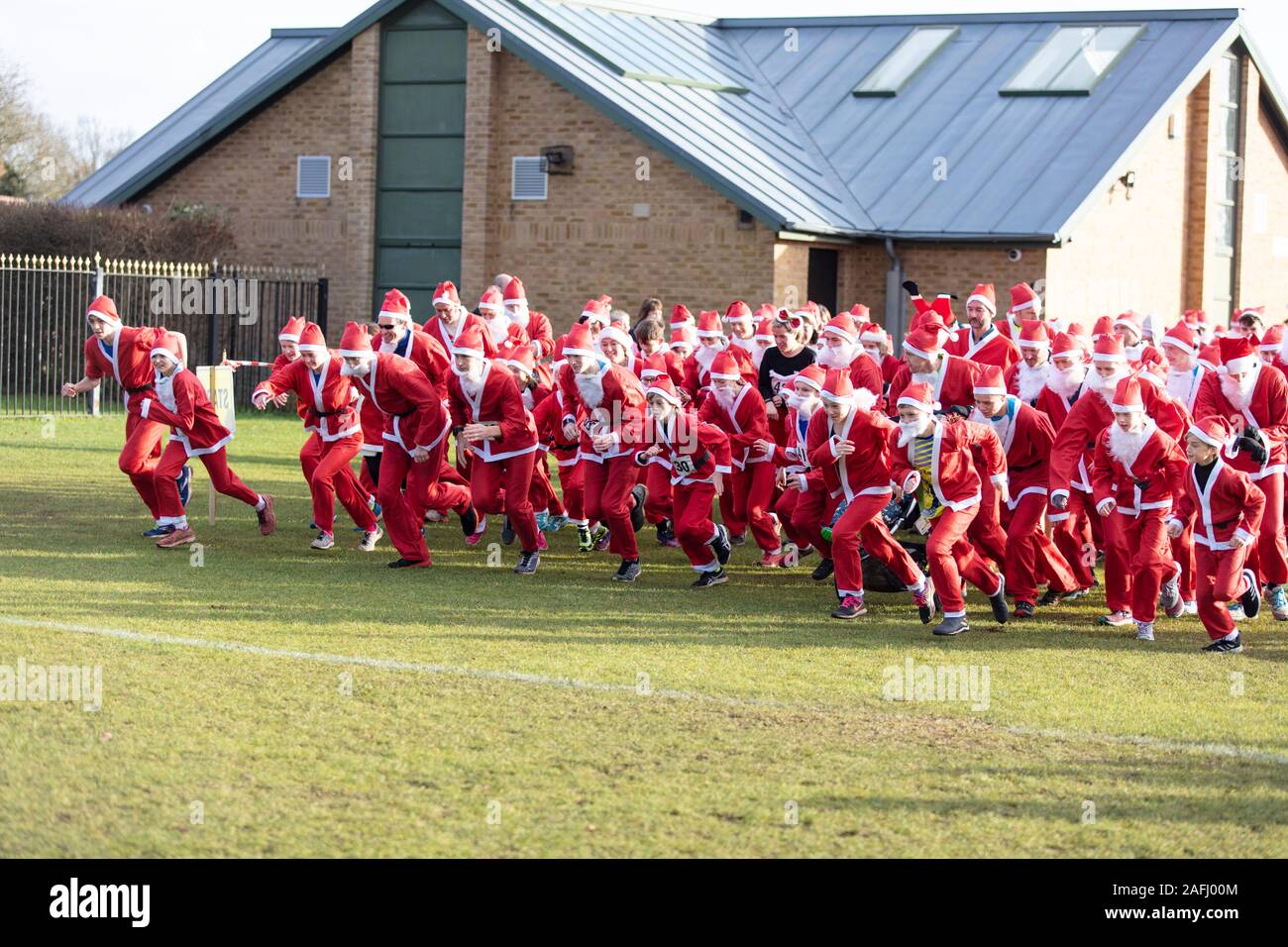 Oxfordshire, UK - December 14th 2019: People dressed as Father Christmas take part in the annual santa fun run. Stock Photo