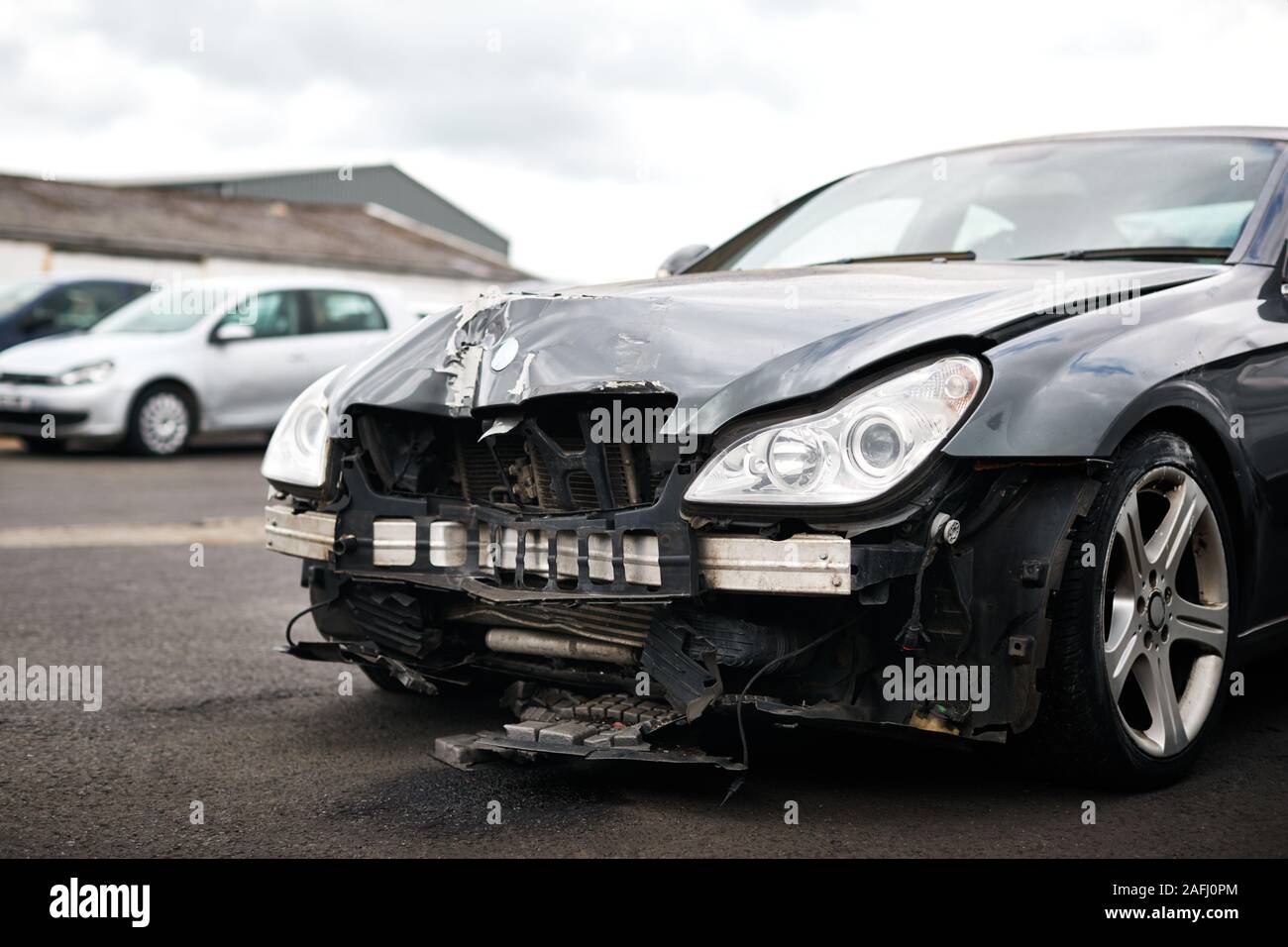 Detail Of Car Damaged In Motor Vehicle Accident Parked In Garage Repair Shop Stock Photo