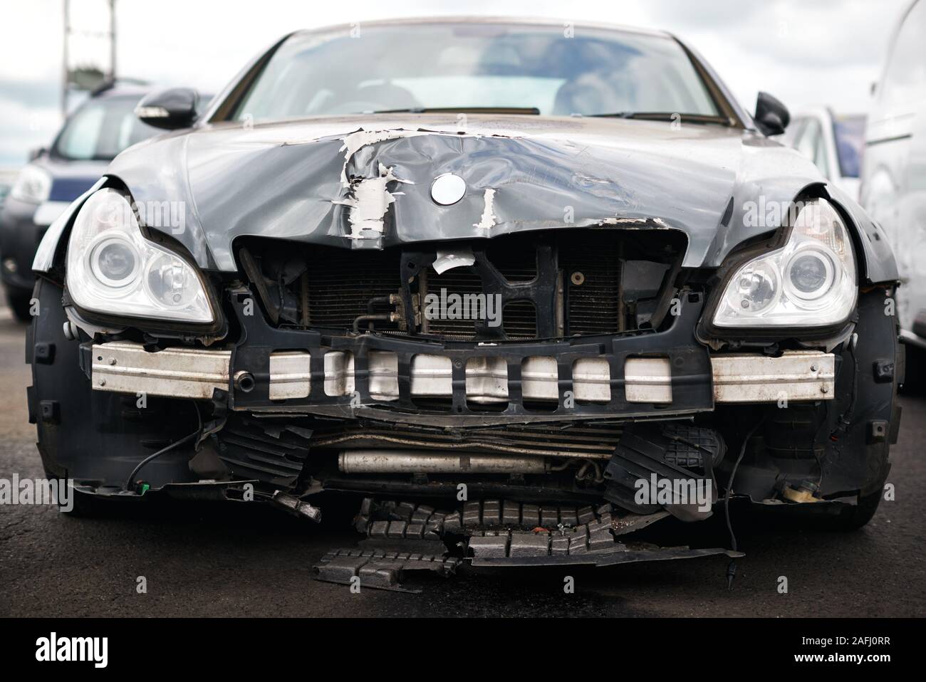 Detail Of Car Damaged In Motor Vehicle Accident Parked In Garage Repair Shop Stock Photo