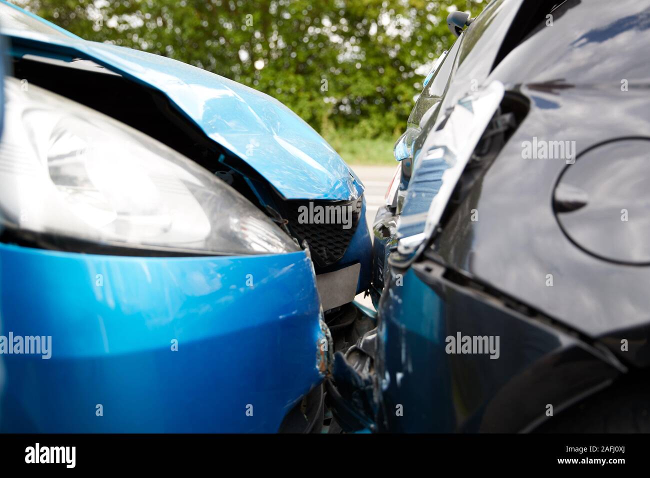 Close Up Of Two Cars Damaged In Road Traffic Accident Stock Photo