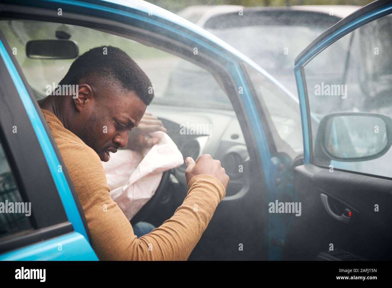 Male Motorist Injured In Car Crash With Airbag Deployed Stock Photo