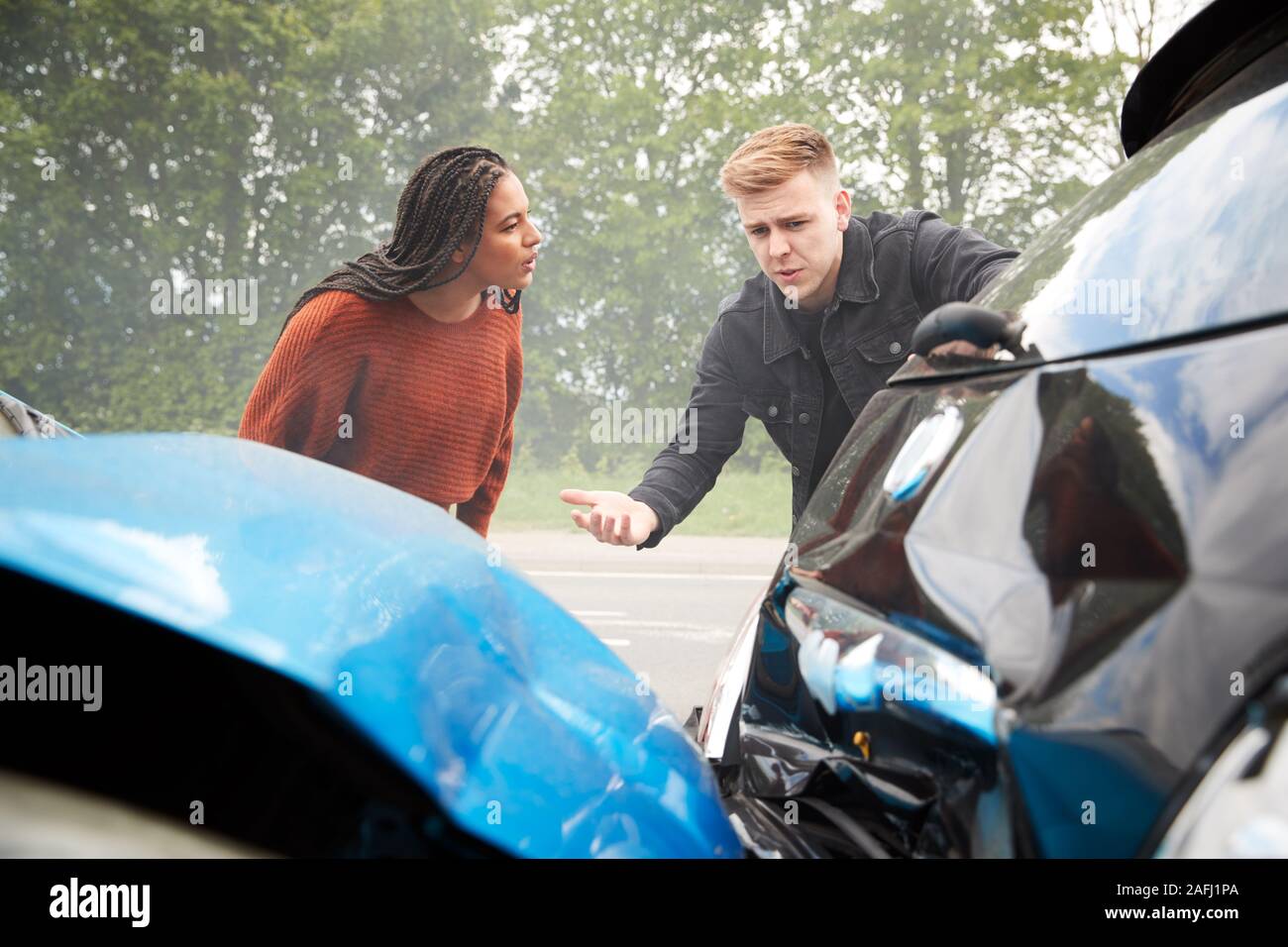 Two Angry Motorists Arguing Over Responsibility For Car Accident Stock Photo