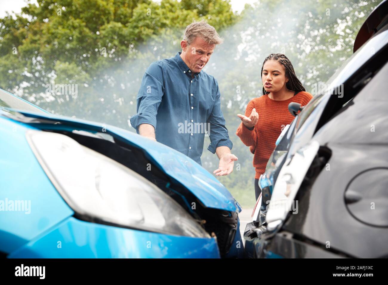 Two Angry Motorists Arguing Over Responsibility For Car Accident Stock Photo