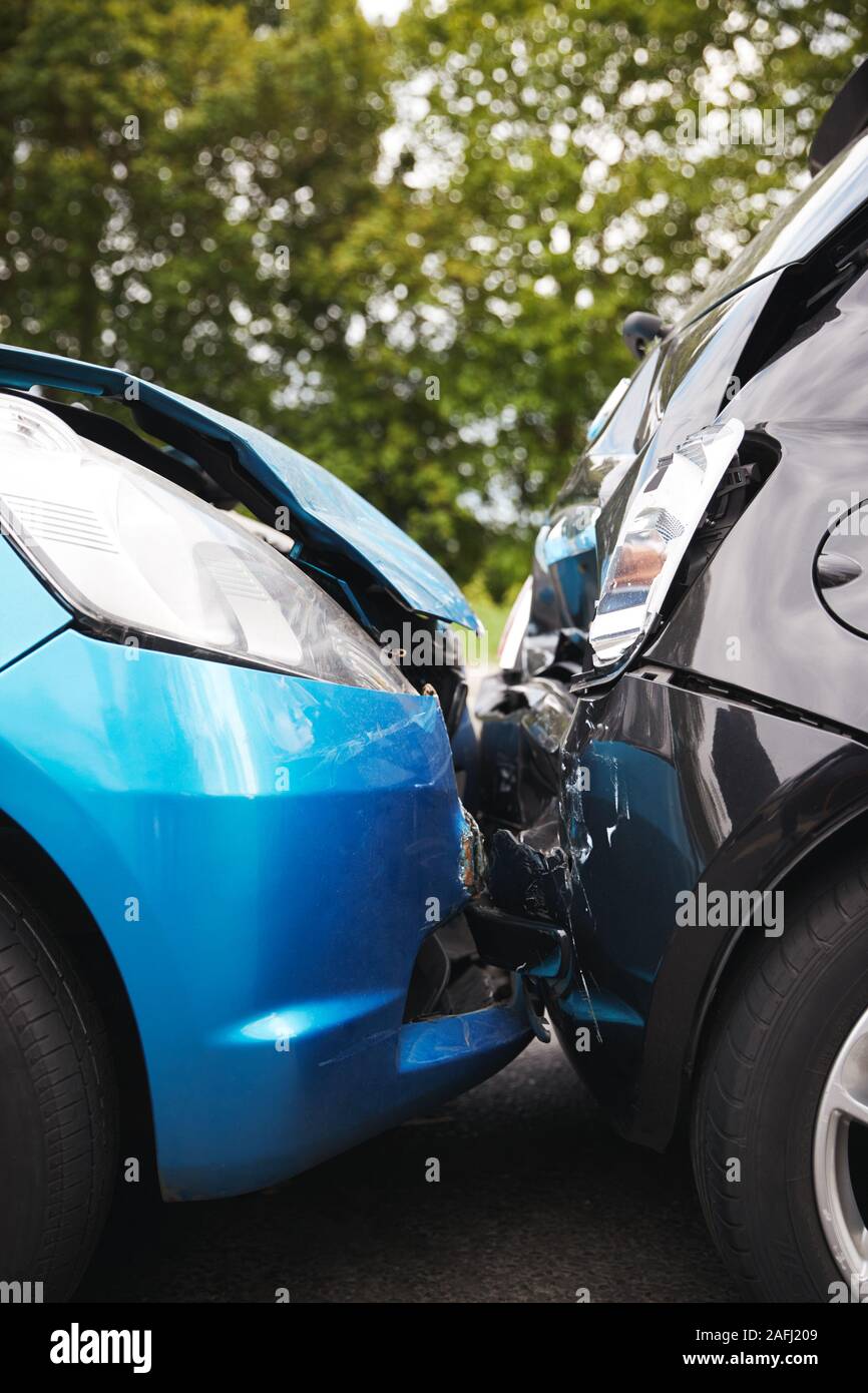 Close Up Of Two Cars Damaged In Road Traffic Accident Stock Photo