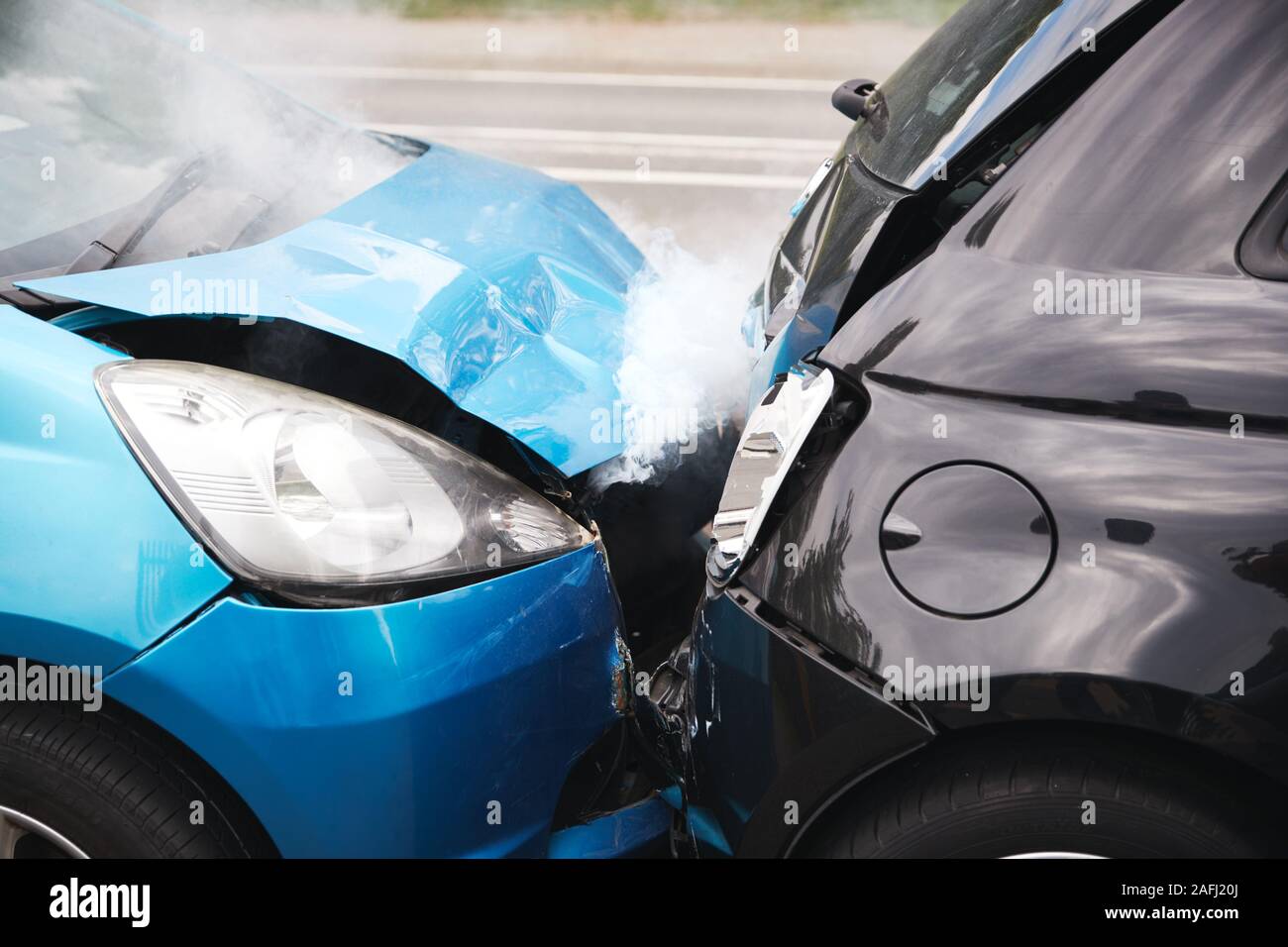 Close Up Of Two Cars Damaged In Road Traffic Accident Stock Photo