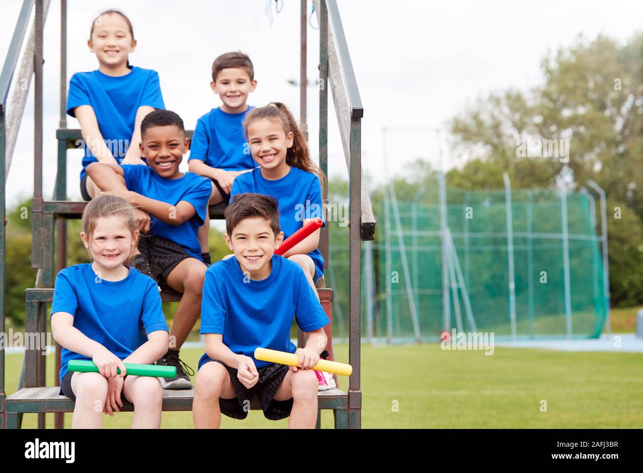 Portrait Of Childrens Athletics Team Preparing For Relay Race On Sports Day Stock Photo