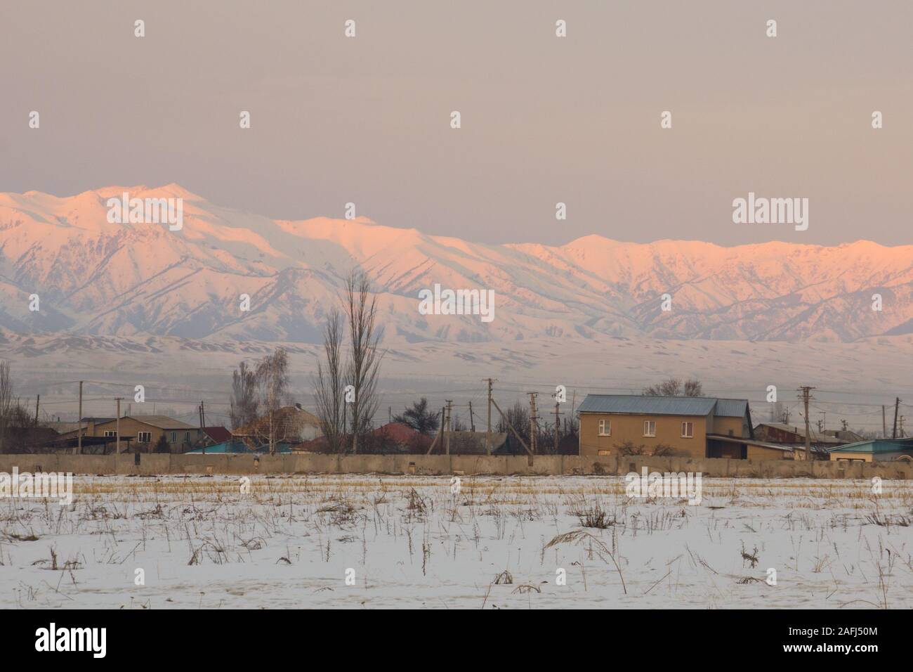 Pink sunset in Tien Shan Mountains in winter, Kyrgyzstan Stock Photo