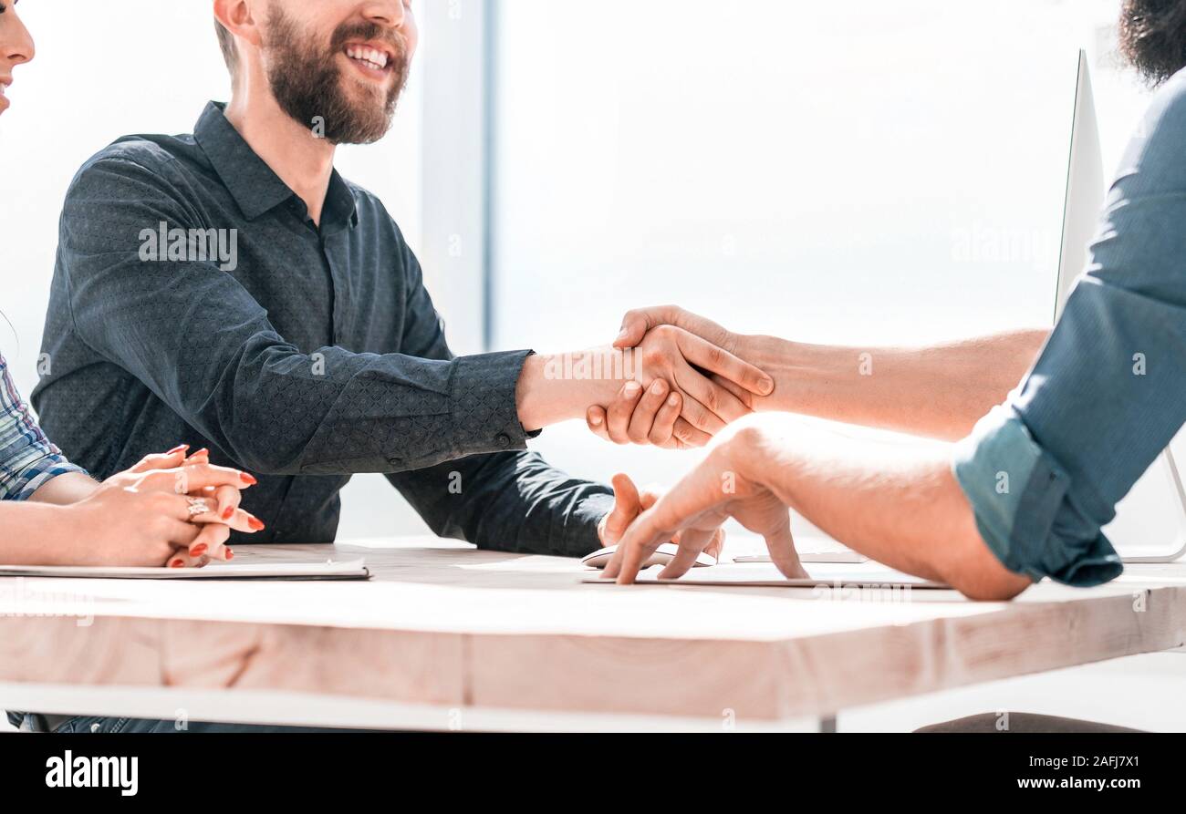 smiling business partners handshake during a business meeting Stock ...