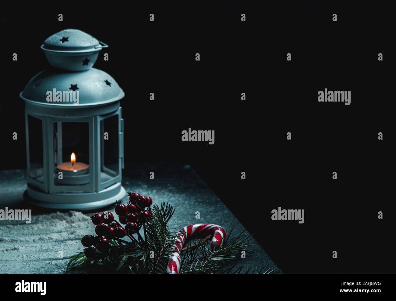 Christmas decoration with fir branches and red berries with lamp on a ...