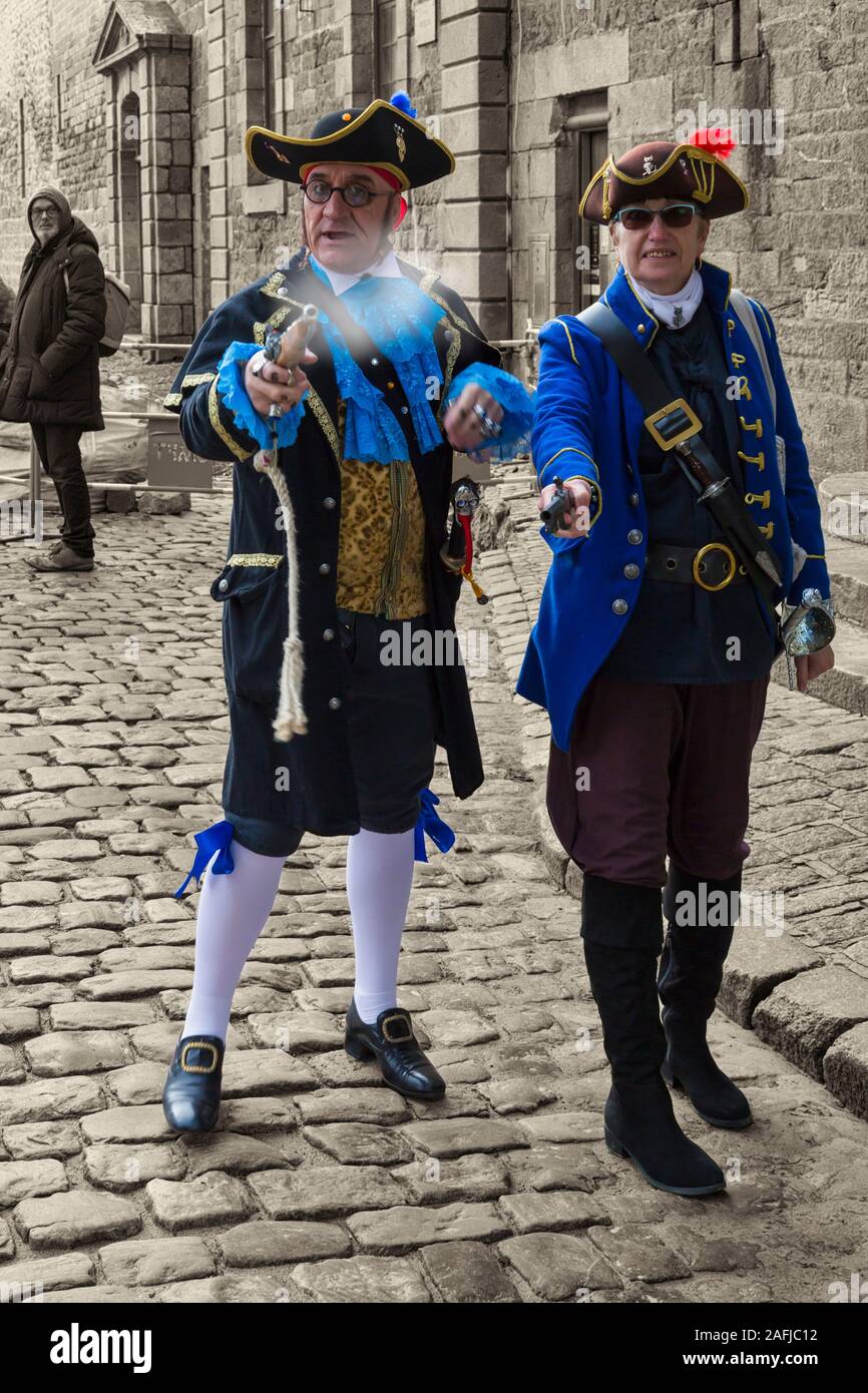 St Malo pirates roaming the streets at old town, St Malo, Saint Malo, Brittany, France in December - selective colour popping on monochromatic Stock Photo