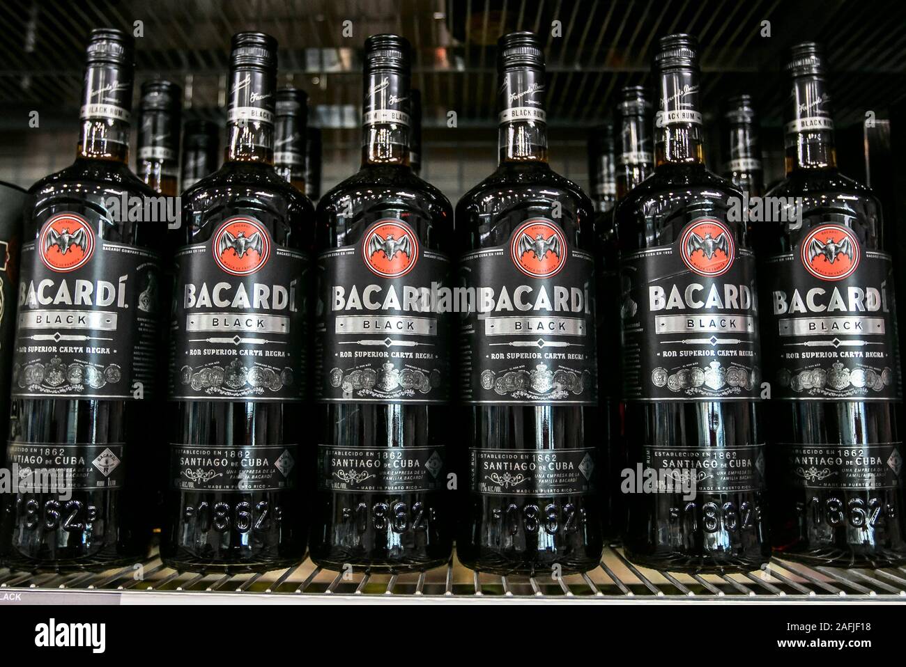 Aruba, 12/2/2019: Bottles of Bacardi Black rum stand on a shelf in a liquor store. Stock Photo