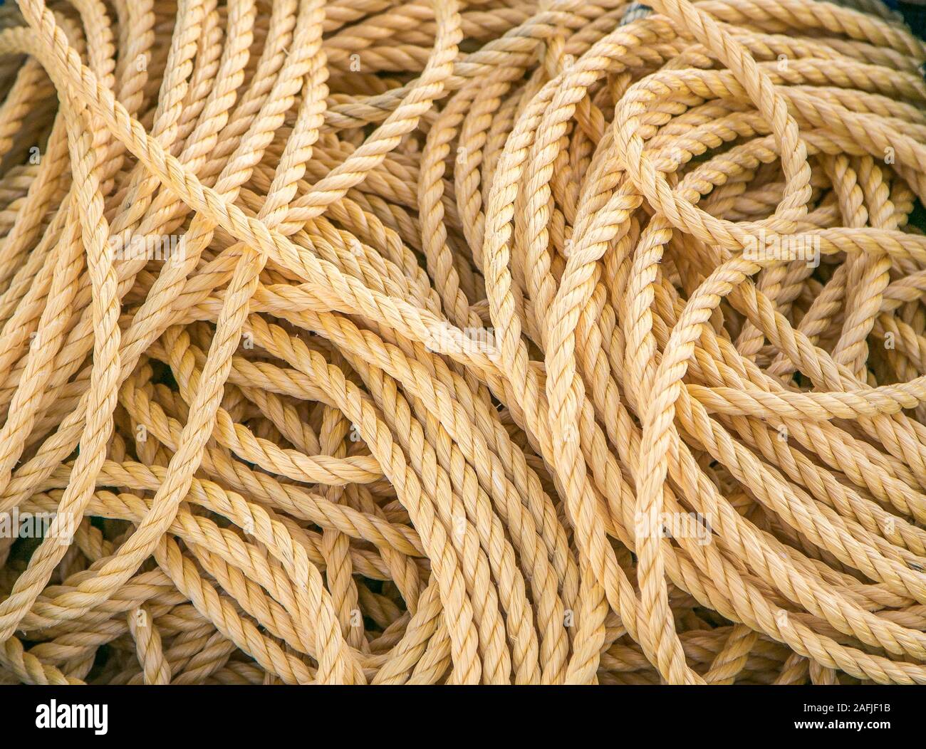 Maritime rope lying in disorderly manner, background. Stock Photo