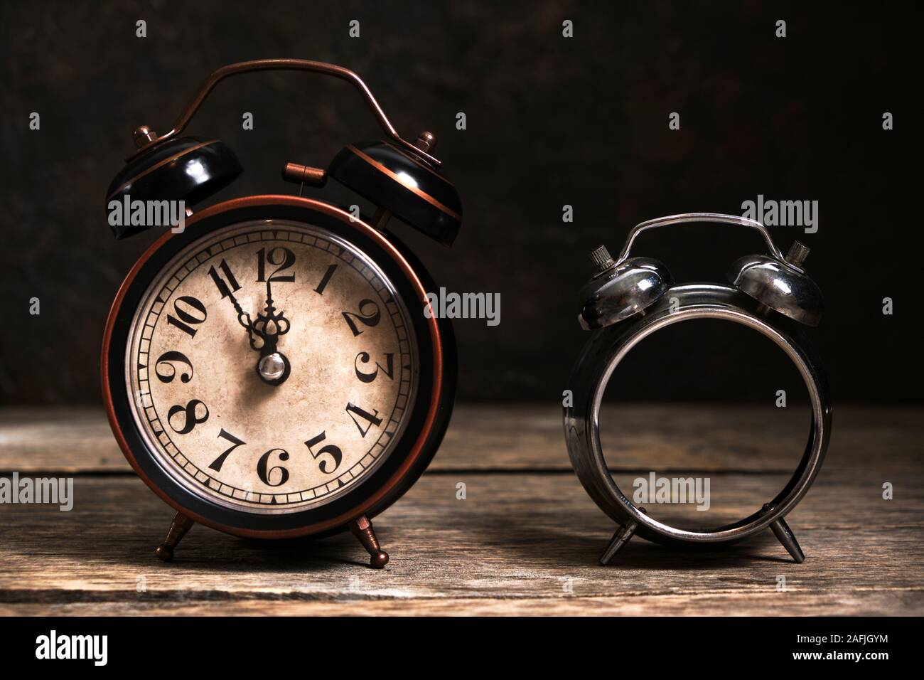 Old retro alarm clocks broken and whole on wooden table Stock Photo - Alamy, image size:1300x956