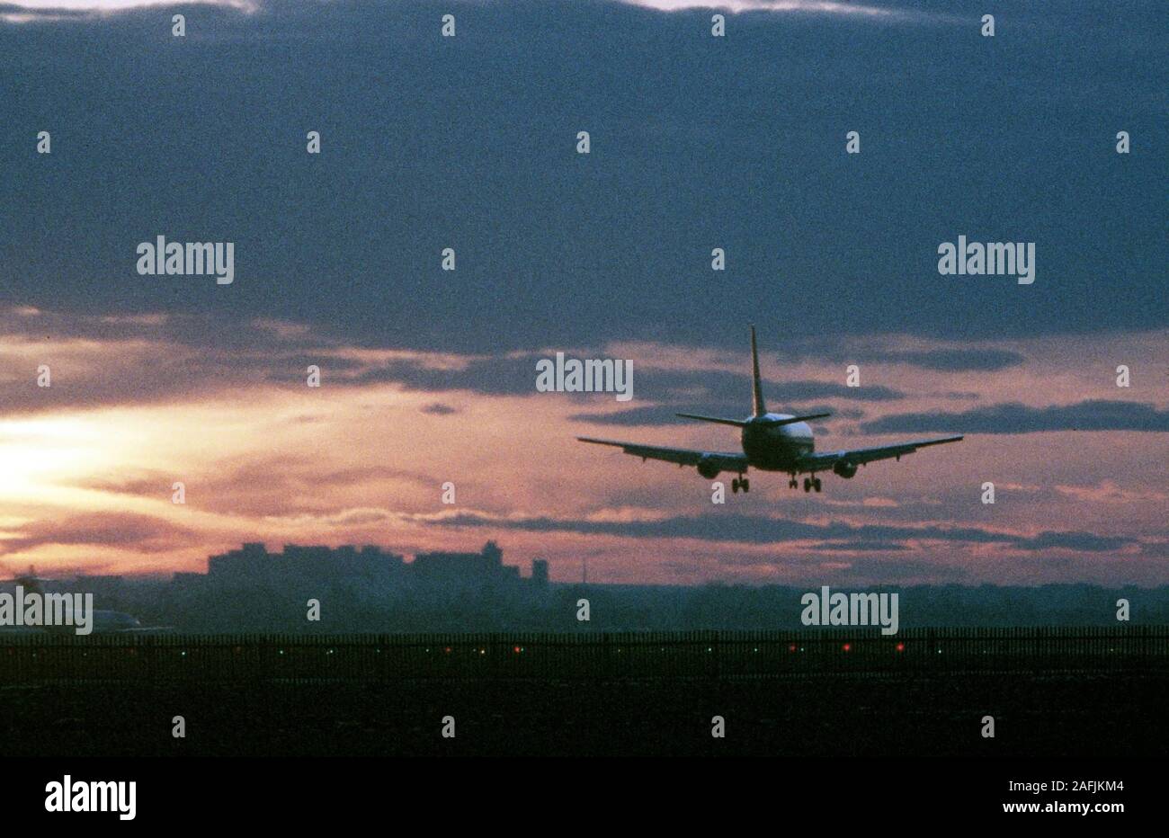 Sunset and landing aircraft on the MunichRiem Airport. In the back the