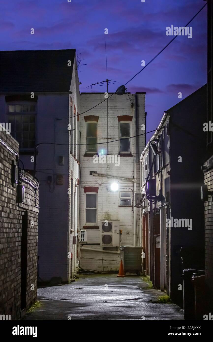 Alleyway between two shops of Wellingborough road, Northampton, UK