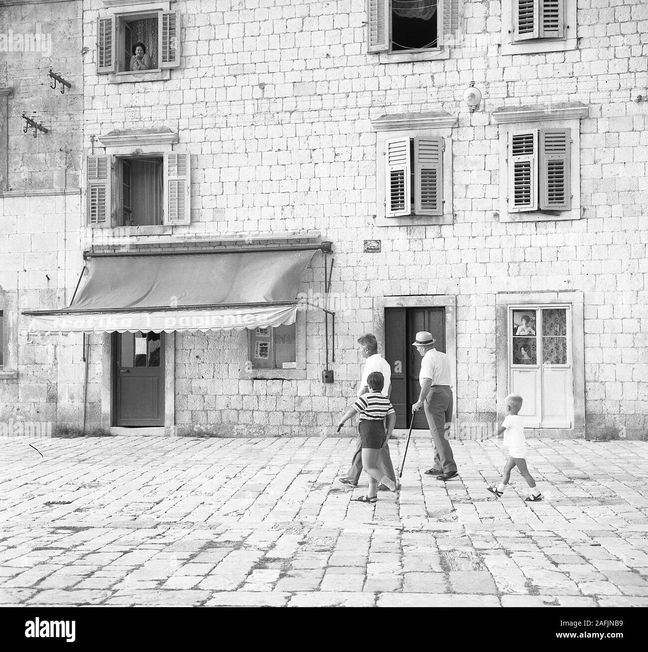 Download Grandfather, father and grandsons on a square in Hvar. In ...